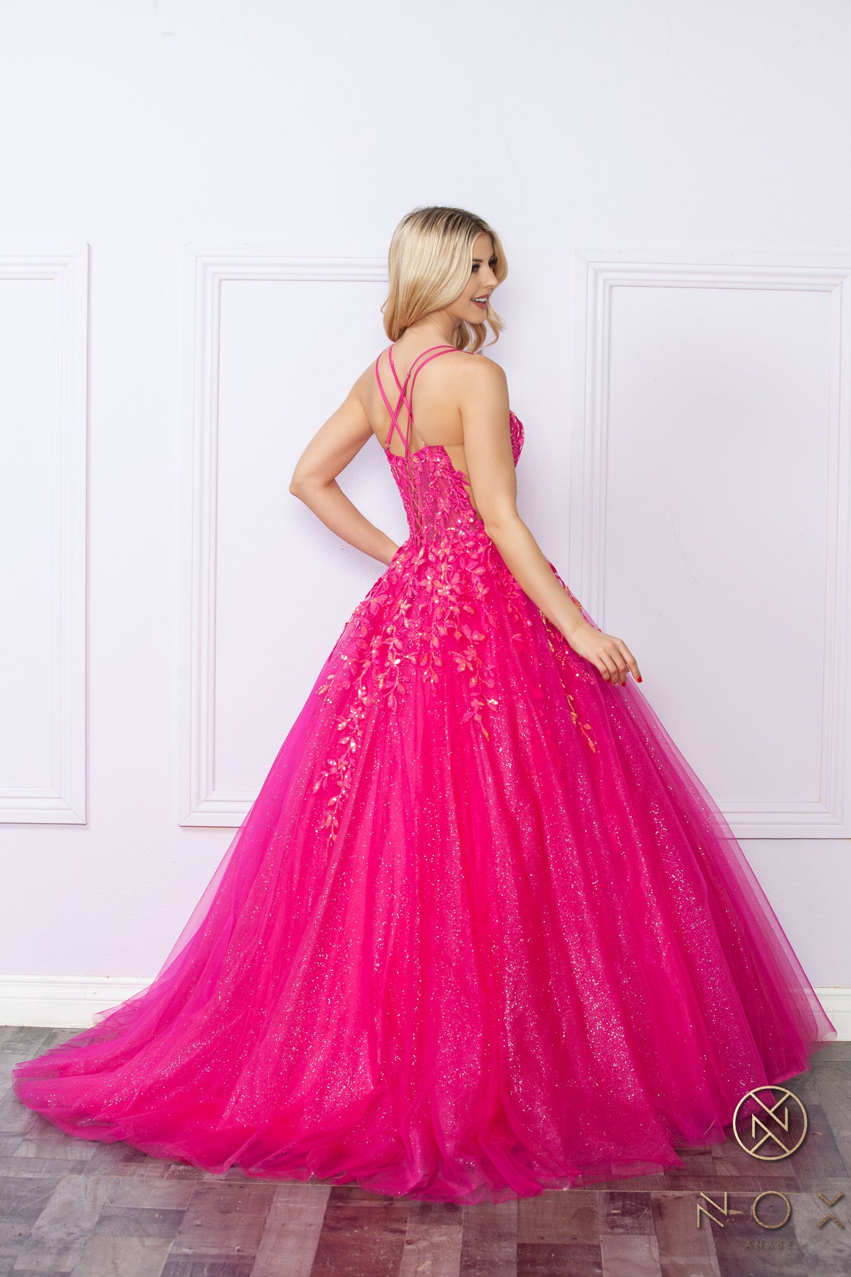 Elevate your prom night look with the Nox Anabel H1271 dress. This elegant A-line gown features a stunning shimmering tulle design with a sheer sequin corset and a flattering scoop neck. Perfect for making a statement with a touch of glamour.  Sizes: 00-16  Colors: Green, Fuchsia, Lavender