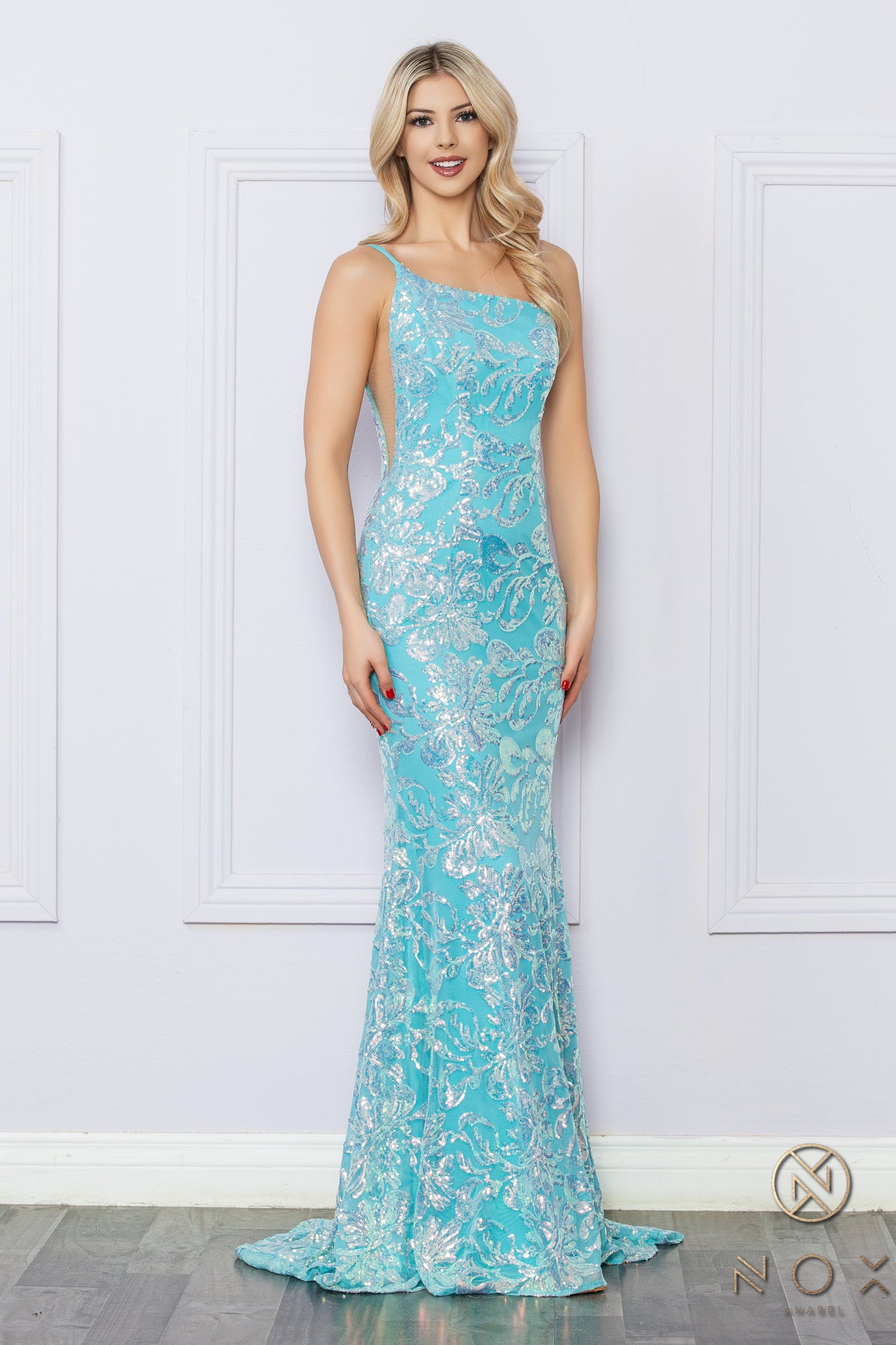 Be the ultimate showstopper in this stunning Nox Anabel R1308 sequin lace one shoulder prom dress. The mermaid silhouette and formal design will give you the confidence to shine on any pageant stage. Guaranteed to make a lasting impression, this gown is a must-have for any special occasion.  Size: 0-16  Colors: Fuchsia, Aqua Blue, White Multi