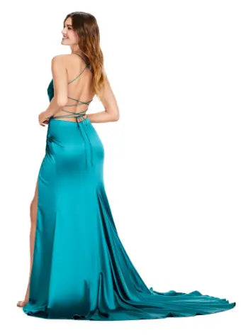 Introducing the Ashley Lauren 11162 Long Prom Dress, a stunning and elegant choice for any formal occasion. Designed with a ruched satin fabric and delicate spaghetti straps, this gown is both comfortable and stylish. Make a statement and stand out in this beautiful dress. This simplistic and stunning spaghetti strap gown features an elegantly draped bodice giving way to a draped skirt that is sure to accentute your curves. The look is accented by a left leg slit and lace up back.