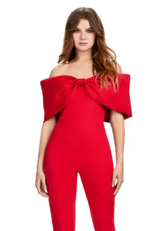 Make a statement at your next formal event with the Ashley Lauren 11414 Off Shoulder Scuba Jumpsuit. Its stylish off-shoulder design and oversized bow add a touch of elegance, while the scuba material provides a comfortable and flattering fit. Perfect for prom or any special occasion. Turn heads in this jumpsuit! This look is complete with an oversized bow off shoulder neckline.