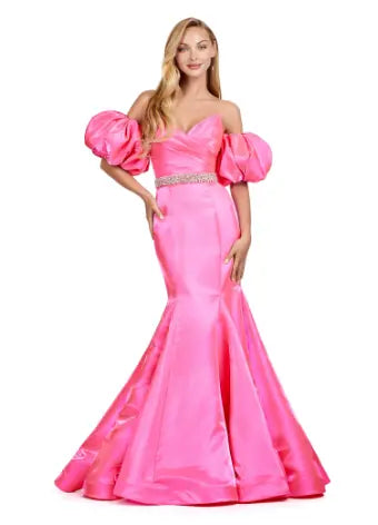 Expertly crafted by Ashley Lauren, this 11419 Long Prom Dress boasts a stunning mermaid silhouette with a strapless design and luxurious satin fabric. The oversized puff sleeves add a bold and elegant touch, making you stand out at any formal event or pageant. Elevate your look with this timeless and sophisticated gown.  Voluminous puff sleeves and a classic sweetheart neckline frame this stunning gown. With its mermaid fit and jeweled belt, this gown is a dream come true!