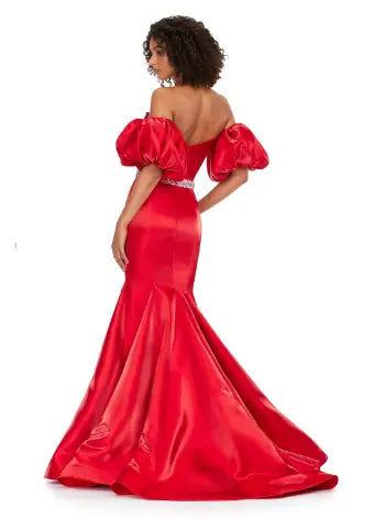 Expertly crafted by Ashley Lauren, this 11419 Long Prom Dress boasts a stunning mermaid silhouette with a strapless design and luxurious satin fabric. The oversized puff sleeves add a bold and elegant touch, making you stand out at any formal event or pageant. Elevate your look with this timeless and sophisticated gown.  Voluminous puff sleeves and a classic sweetheart neckline frame this stunning gown. With its mermaid fit and jeweled belt, this gown is a dream come true!