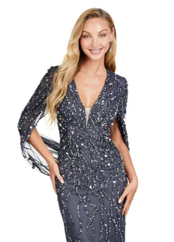 This long prom dress by Ashley Lauren 11430 features a stunning sequin V-neck and elegant cape sleeves, perfect for a formal pageant or evening event. The modern design and quality construction make it a must-have for any fashion-forward individual looking to make a statement. Look and feel confident in this unique, eye-catching gown. 