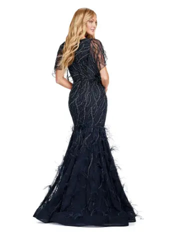 Make a statement in the Ashley Lauren 11431 Long Prom Mermaid Dress. This elegant gown features intricate beading and an asymmetrical cape, creating a stunning silhouette that will turn heads. Perfect for formal occasions and pageants, this dress will make you feel confident and glamorous. Classy with a twist. This fully beaded gown features a sheer asymmetric cape and feathers throughout the skirt.