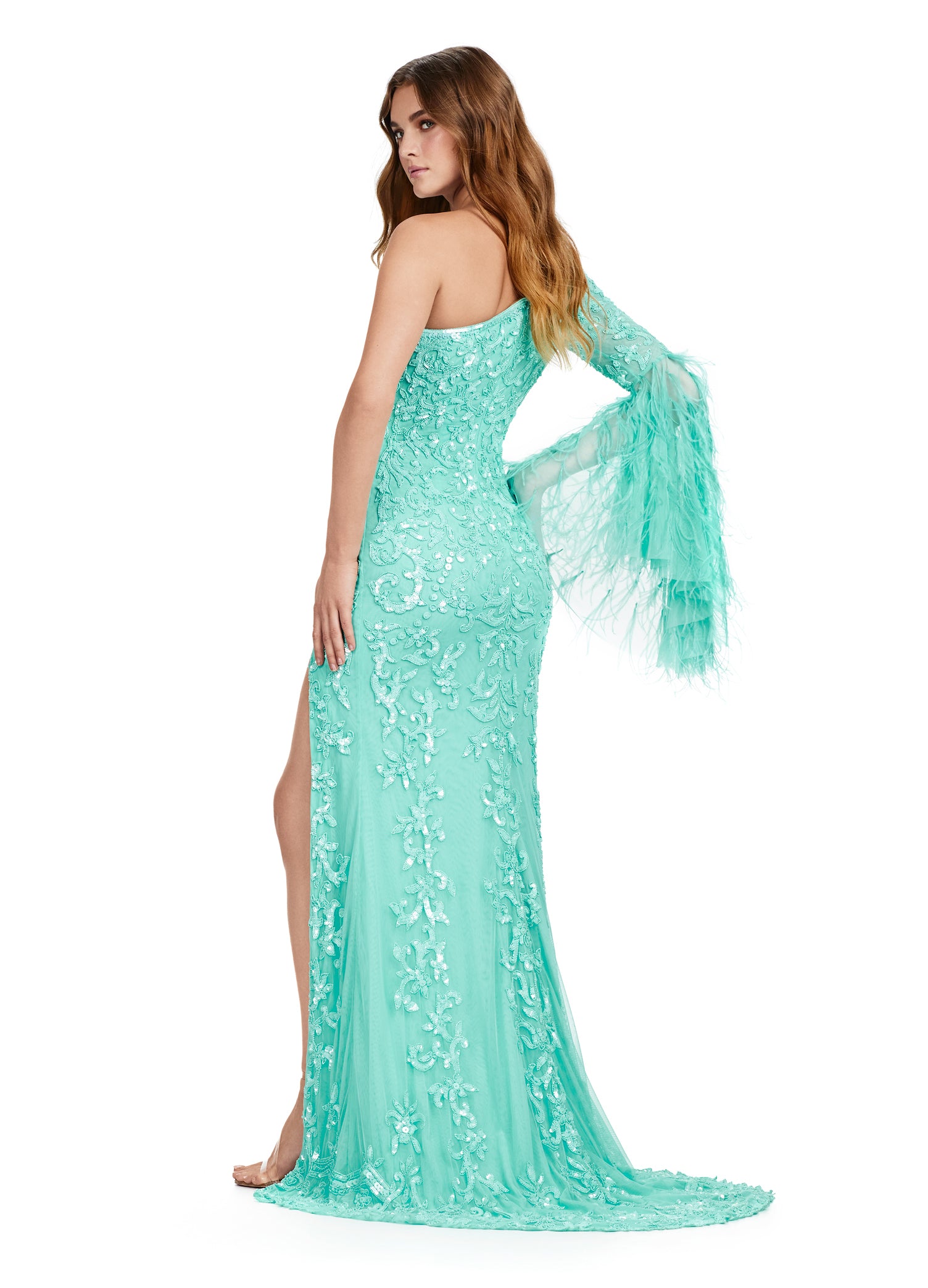 Make a statement in the Ashley Lauren 11452 Long Prom Dress. This stunning gown features a one shoulder design and full sequin embellishments, perfect for standing out at prom or a formal pageant. The bell sleeves add a touch of elegance to this standout piece. Available in multiple sizes. Elegant and fab! This one shoulder, fully beaded gown features a left leg slit and a dramatic feathered bell sleeve that takes this look to the next level.