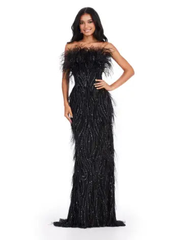 This Ashley Lauren long prom dress features a strapless, fully beaded bodice and a stunning feathered skirt, making it the perfect choice for any formal pageant. The intricate detailing and elegant design truly make this gown stand out and ensure you'll make a statement at any event. We're here for this look! This fully beaded strapless gown features an intricate beaded design and feathers throughout to help you stand out at your next event.