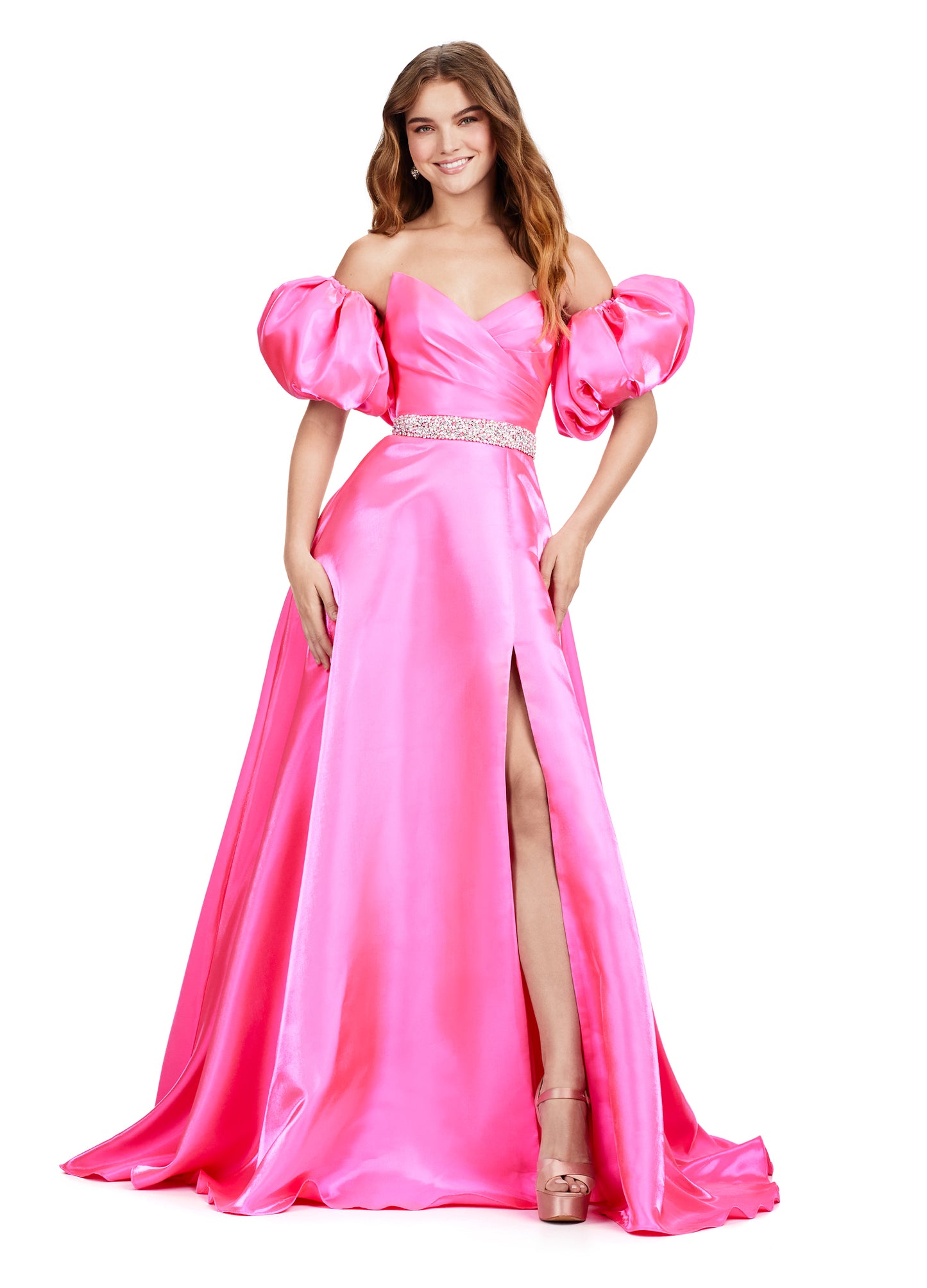 Elevate your formal look with the Ashley Lauren 11474 Long Prom Dress. This elegant strapless satin ball gown boasts a beaded belt, detachable puff sleeves, and a timeless pageant-style design. Perfect for making a statement at any event, this dress exudes sophistication and style. Be memorable in this strapless satin ball gown. This dress features a beaded belt detail, a left leg slit and detachable puff sleeves.