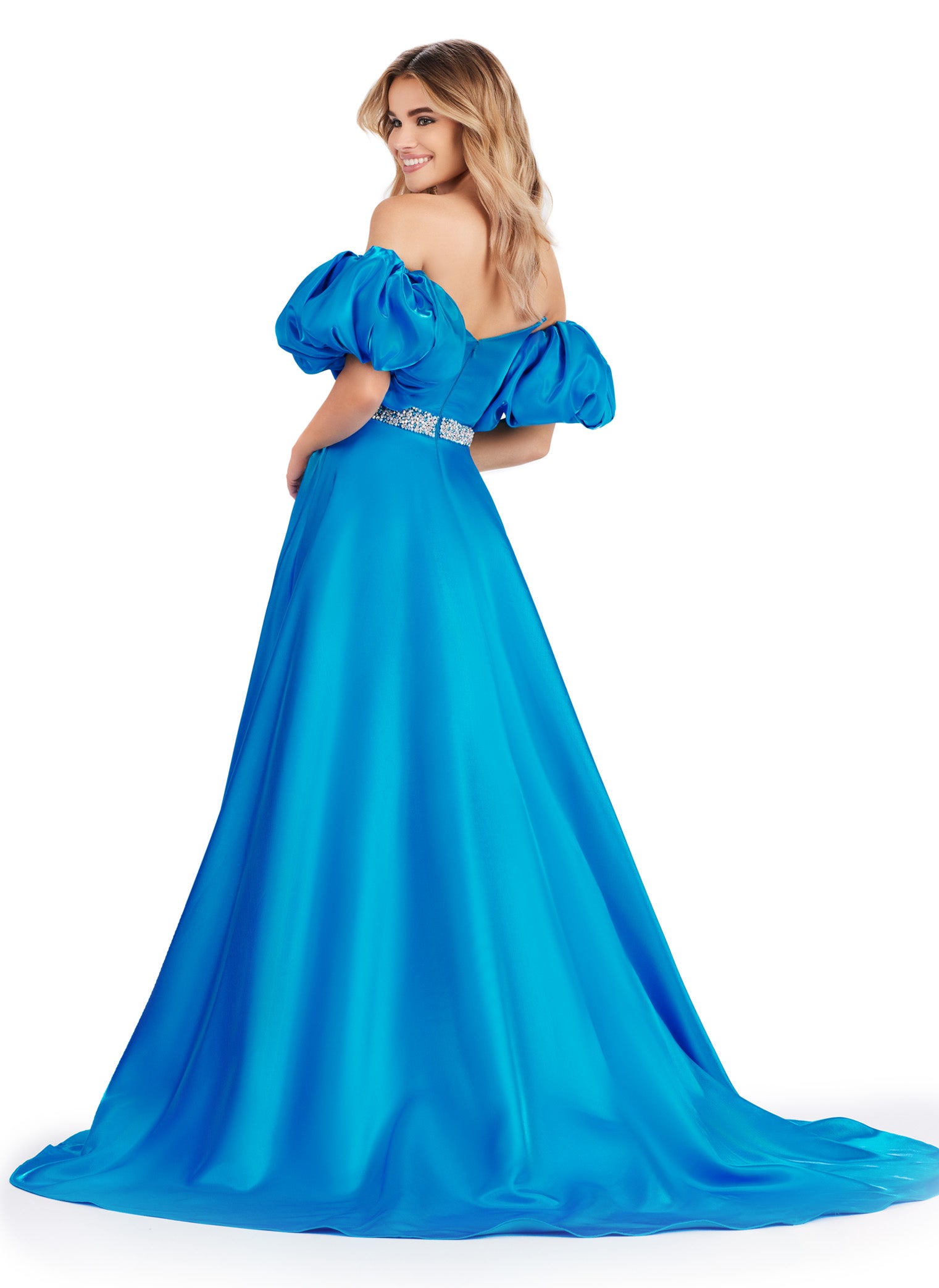 Elevate your formal look with the Ashley Lauren 11474 Long Prom Dress. This elegant strapless satin ball gown boasts a beaded belt, detachable puff sleeves, and a timeless pageant-style design. Perfect for making a statement at any event, this dress exudes sophistication and style. Be memorable in this strapless satin ball gown. This dress features a beaded belt detail, a left leg slit and detachable puff sleeves.