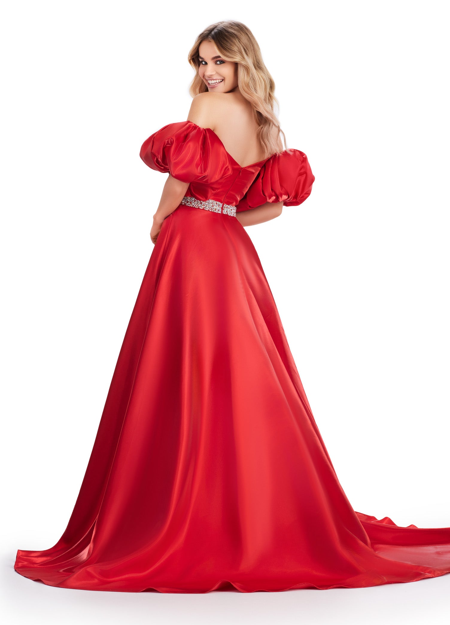 Elevate your formal look with the Ashley Lauren 11474 Long Prom Dress. This elegant strapless satin ball gown boasts a beaded belt, detachable puff sleeves, and a timeless pageant-style design. Perfect for making a statement at any event, this dress exudes sophistication and style. Be memorable in this strapless satin ball gown. This dress features a beaded belt detail, a left leg slit and detachable puff sleeves.