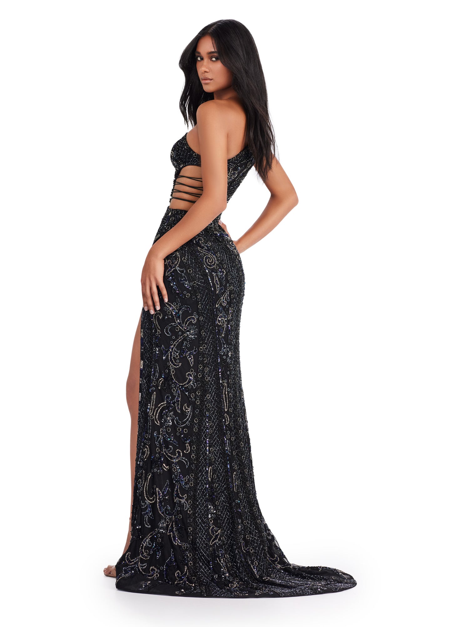 Expertly crafted for a stunning silhouette, the Ashley Lauren 11489 Long Prom Dress features a fitted one shoulder design with intricate sequin detailing. With stylish cut outs and a subtle slit, this formal pageant gown exudes elegance and sophistication. Perfect for making a statement at any special occasion. Wow the crowd in this fabulous fully beaded one shoulder gown. This dress features an intricate beaded design and asymmetric cut outs through out the bustier.