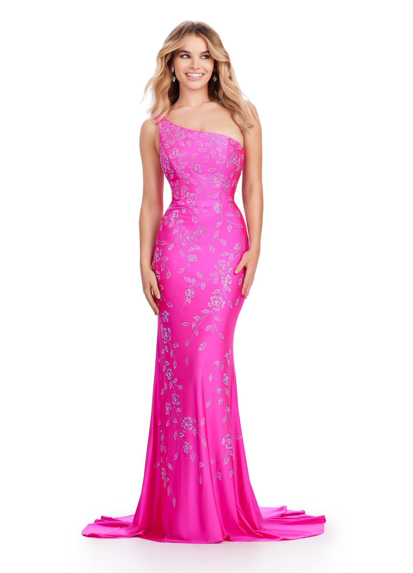 Make a stunning entrance in the Ashely Lauren 11525 Long Prom Dress. Featuring a one shoulder design and a press on floral bead pattern, this gown exudes sophistication and elegance. The jersey fabric offers a comfortable and flattering fit, perfect for any formal occasion. Make a statement in this pageant-worthy gown. This one shoulder jersey gown features a delicate multi-colored heat set stone floral bead pattern that cascades down onto the skirt.