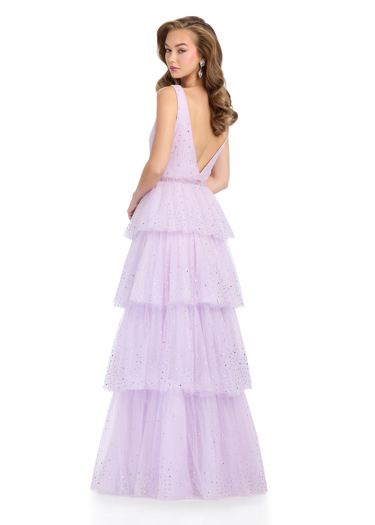 Elevate your formal wear with the Ashley Lauren 11894 Shimmer Layer Bow Prom Dress. This v-neck crystal gown boasts a sleek A-line silhouette that is both flattering and elegant. The shimmer layer adds a touch of glamour, while the bow detail adds a playful touch. Perfect for any formal occasion.