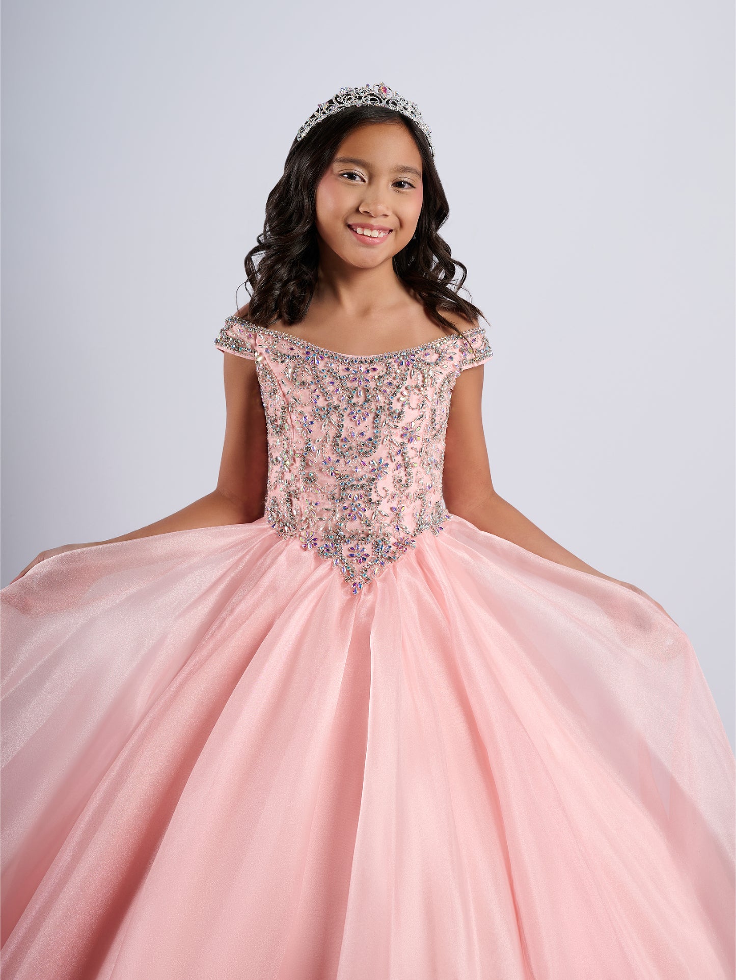 Elevate your little girl's pageant game with the Tiffany Princess 13788 dress. The stunning crystal bodice sparkles underneath the off-shoulder ballgown, making her stand out on stage. The A-line cut flatters any figure, creating a timeless and elegant look for any pageant.

Sizes: 2-16

Colors: Blush, Royal, White