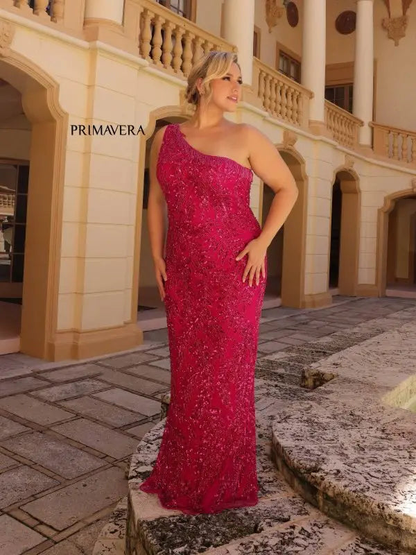 Make a statement in Primavera Couture's 14047 Plus Size Sequin Prom Dress. Designed to hug your curves, this dress features an asymmetrical one shoulder neckline, Sequins, beading and fringe detail. For a glamorous look, pair it with strappy heels and a small clutch.  Sizes: 14W-24W  Colors: Black, Fuchsia, Platinum 