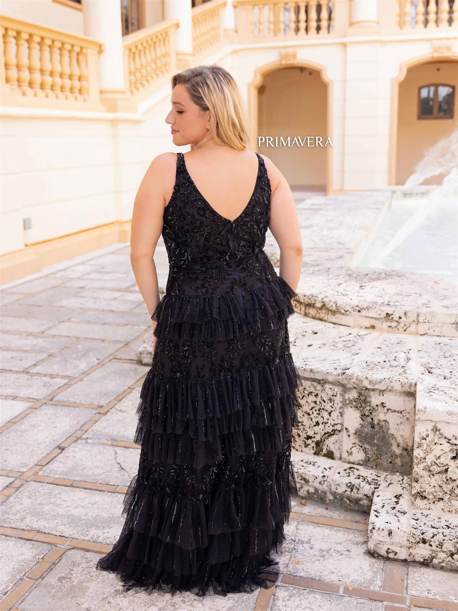 This elegant Primavera Couture 14052 prom dress is designed to showcase your curves with its long, fitted silhouette. The sequin detailing adds a touch of glamour, while the tiered skirt adds movement and volume. Perfect for formal occasions, this plus size gown is sure to turn heads.