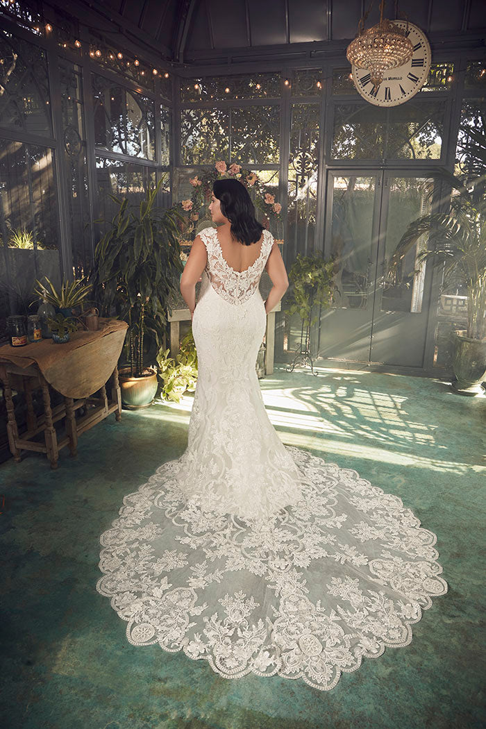 A portrait of timeless beauty, Justine Style 2485 by Casablanca Bridal is a vision of romanticism and femininity. Crafted from exquisite stretch chiffon, this figure-loving fit and flare silhouette features a plunging neckline and wide straps that frame a low-cut laced back. 