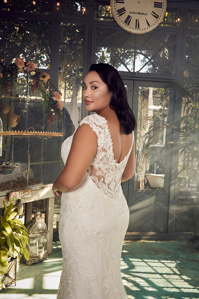 A portrait of timeless beauty, Justine Style 2485 by Casablanca Bridal is a vision of romanticism and femininity. Crafted from exquisite stretch chiffon, this figure-loving fit and flare silhouette features a plunging neckline and wide straps that frame a low-cut laced back. 