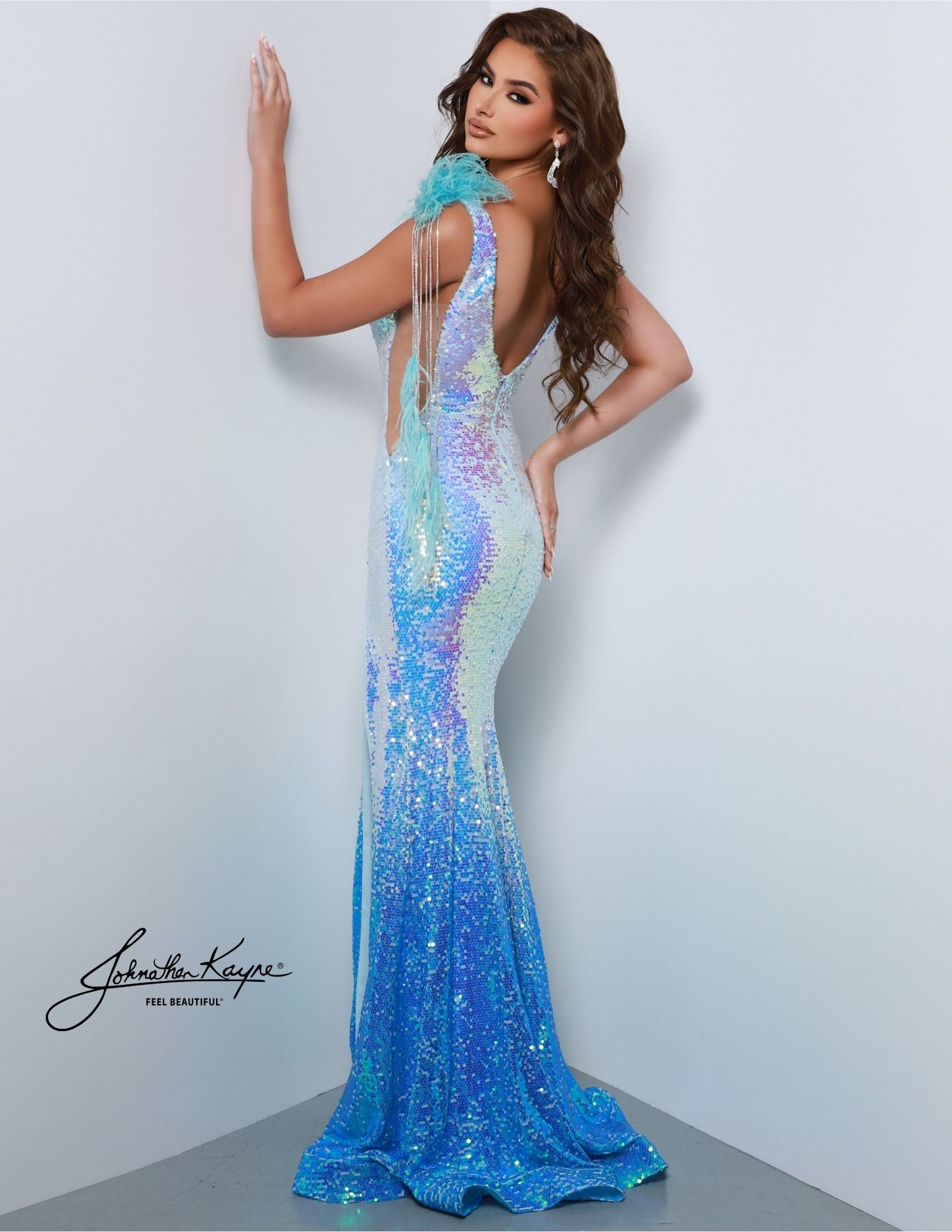 Be the belle of the ball wearing this Johnathan Kayne 2829 Long Prom Dress. It features a V neck and high slit, embellished with ombre sequins for extra sparkle. This formal pageant gown is perfect for your grand entrance. Sizzle and stun the room! Our Ombre Sequin Mesh gown featuring detachable feathered rhinestone chains and a slit will leave everyone talking at your next event!