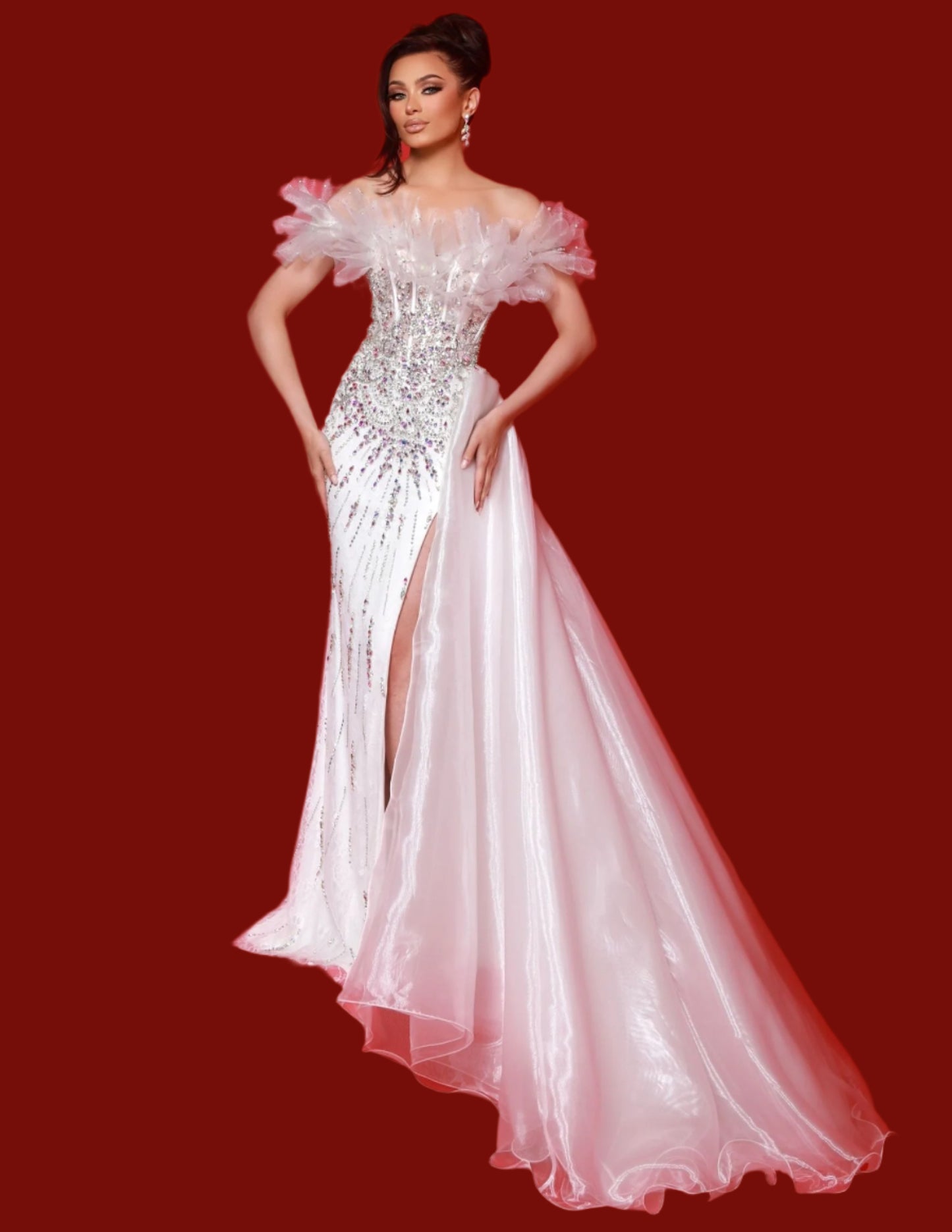 This Johnathan Kayne 3057 dress boasts a beaded corset, an elegant overskirt, and an off-the-shoulder, puff sleeve design. Perfect for prom or pageants, this dress exudes class and sophistication while highlighting your figure. The intricate beading adds a touch of sparkle, making you stand out in any crowd. Strive for fabulous in this dazzling beaded dress! Featuring delicate organza, stretch lace, and a fearless leg slit, its strapless design dazzles with off-the-shoulder flares and an attached hip cape. 