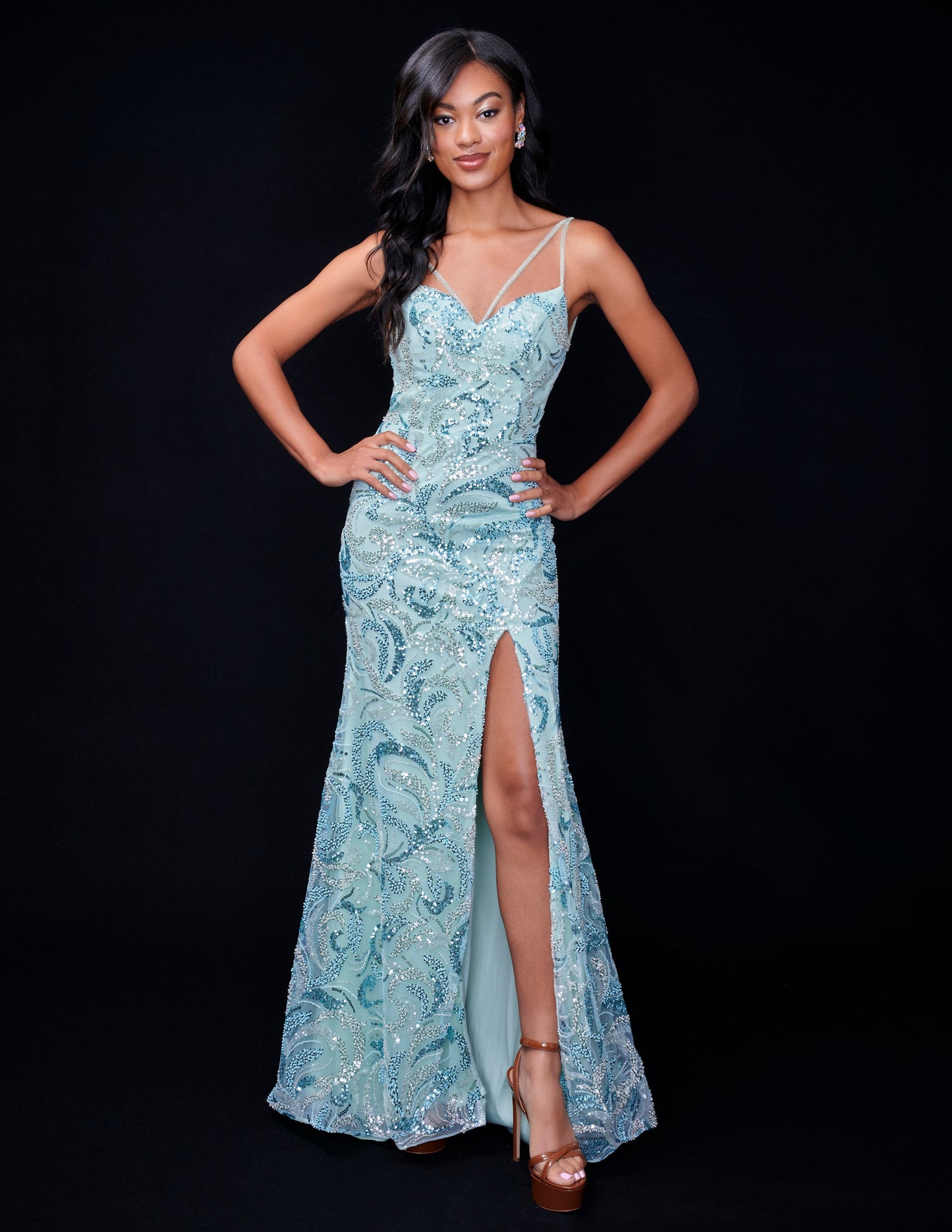 Nina Canacci presents an elegant formal dress for your next special occasion. With intricate beaded and sequin details, this backless gown features a stunning v-neck and thigh-high slit for a touch of glamour. Make a statement at prom or any evening event with this show-stopping design.