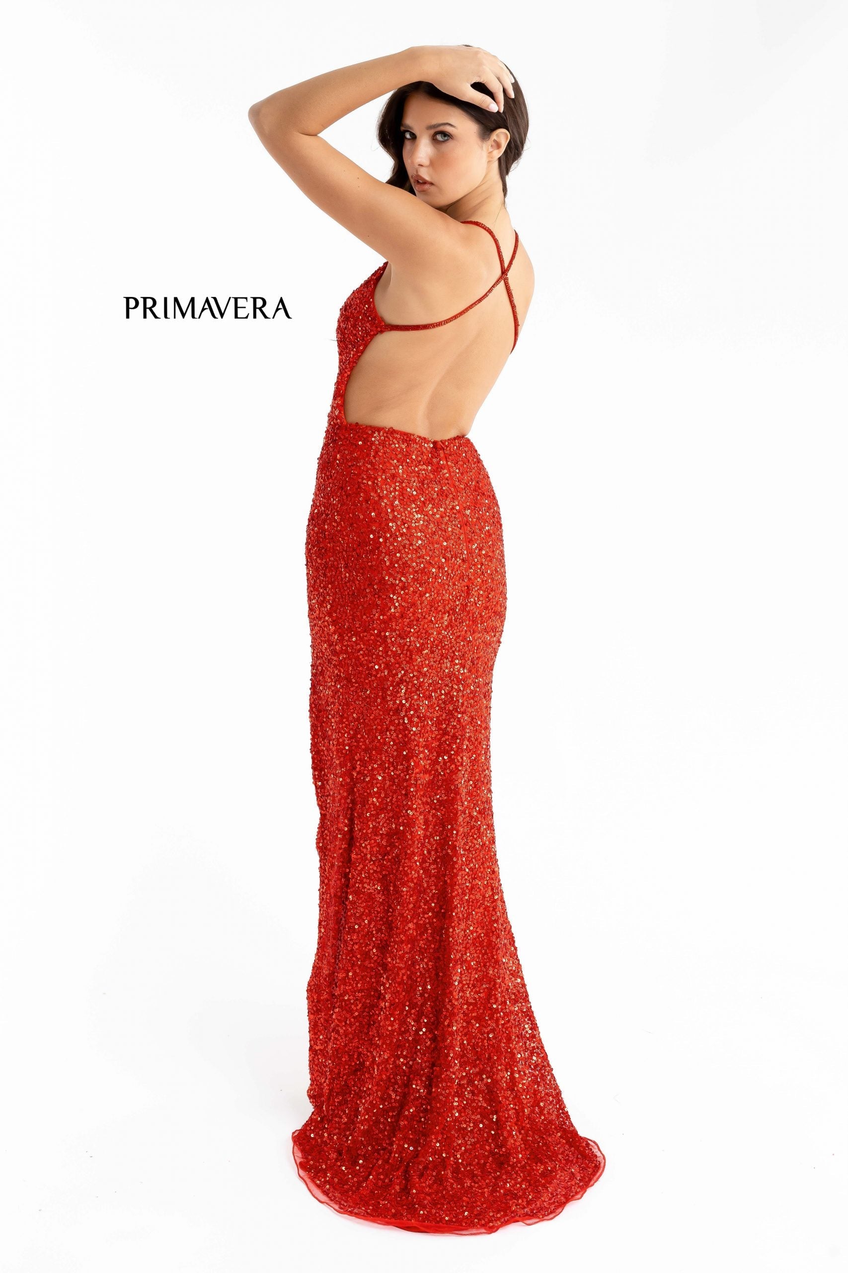 Primavera Couture 3291 Exclusive Prom Dresses.  This long prom dress is embellished throughout with shimmering sequins.  This impressive gown showcases a v neckline, thin beaded straps and crisscrossed straps in the open back. The long slim skirt has a sultry high side front slit. 