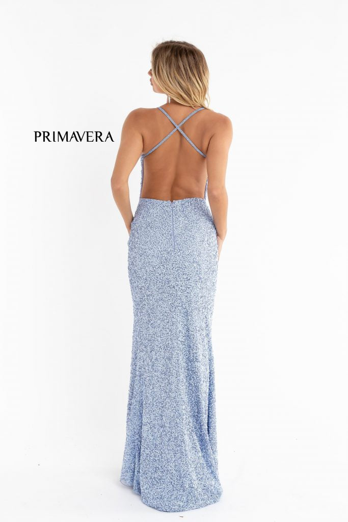 Primavera Couture 3291 Exclusive Prom Dresses.  This long prom dress is embellished throughout with shimmering sequins.  This impressive gown showcases a v neckline, thin beaded straps and crisscrossed straps in the open back. The long slim skirt has a sultry high side front slit. 