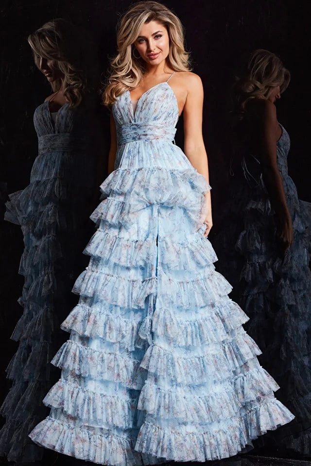 The Jovani 36571 is a vision of elegance in the formal collection. Crafted from mesh, this A-line prom dress showcases a delicate floral print, infusing the gown with a sense of whimsy and charm. The ruffle skirt adds a playful element, creating movement and enhancing the overall romantic aesthetic. A high slit in the skirt introduces an alluring touch, allowing for graceful movement.