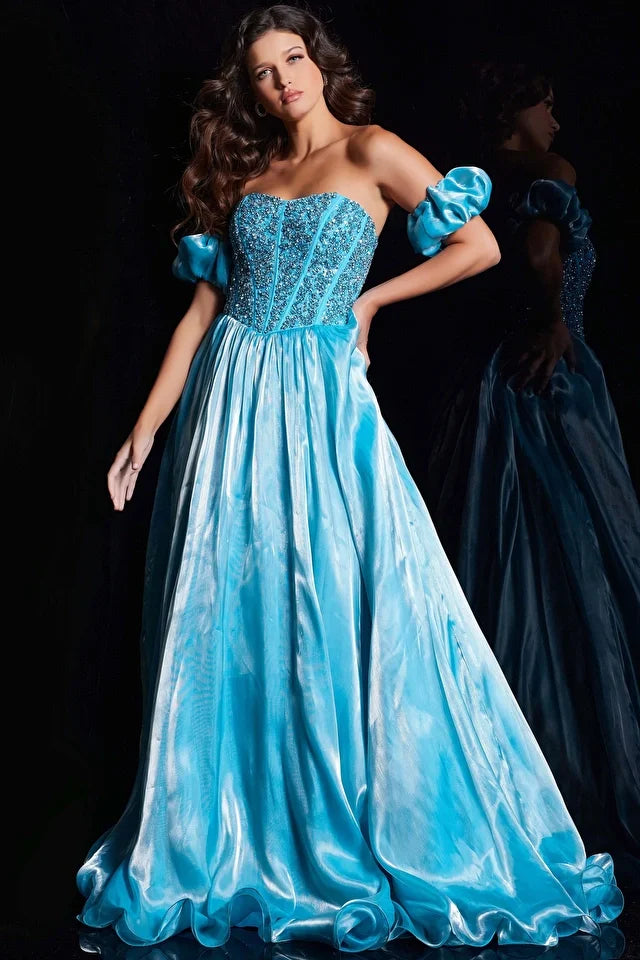 Elevate your prom or pageant look with the Jovani 36591 Long Prom Dress. This stunning gown features a corset fit and flare silhouette with intricate beaded details, and detachable ruffle sleeves for added drama. Perfect for making a statement and standing out in a sea of dresses. Elevate your prom or pageant look with the Jovani 36591 Long Prom Dress - a captivating combination of a corset fit and flare silhouette and exquisite beaded embellishments. 