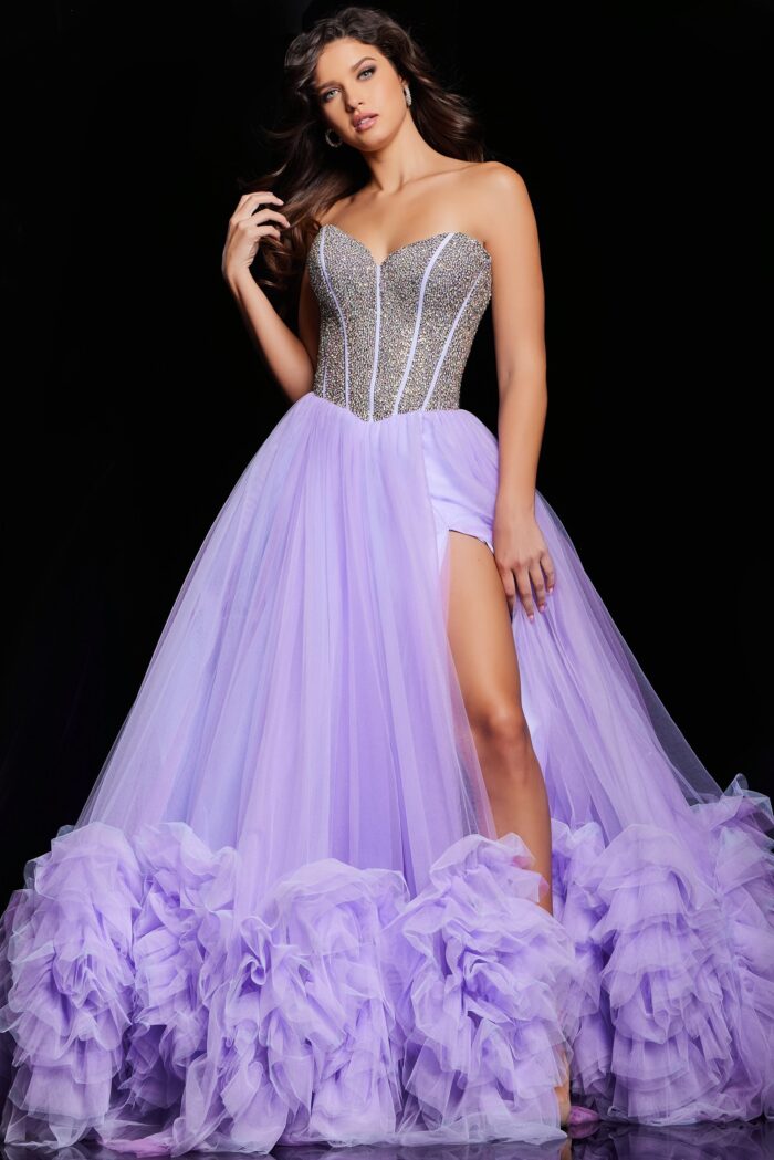 As a formal gown expert, trust the Jovani 37199 Ruffle Tulle A Line Dress to elevate your prom or pageant look. With a stylish crystal corset and elegant ruffle tulle A line design, this gown exudes sophistication. The slit adds a touch of allure, making you stand out from the crowd.&nbsp;