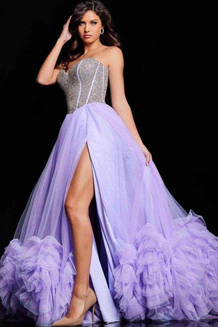 As a formal gown expert, trust the Jovani 37199 Ruffle Tulle A Line Dress to elevate your prom or pageant look. With a stylish crystal corset and elegant ruffle tulle A line design, this gown exudes sophistication. The slit adds a touch of allure, making you stand out from the crowd.&nbsp;