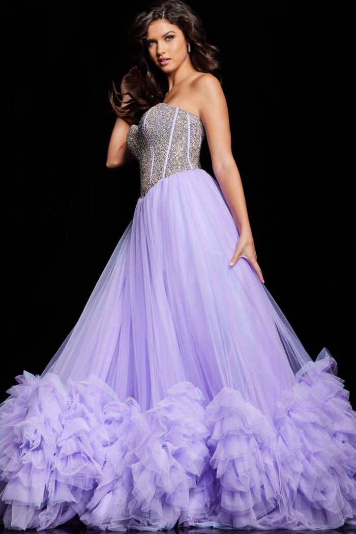 As a formal gown expert, trust the Jovani 37199 Ruffle Tulle A Line Dress to elevate your prom or pageant look. With a stylish crystal corset and elegant ruffle tulle A line design, this gown exudes sophistication. The slit adds a touch of allure, making you stand out from the crowd.&nbsp;