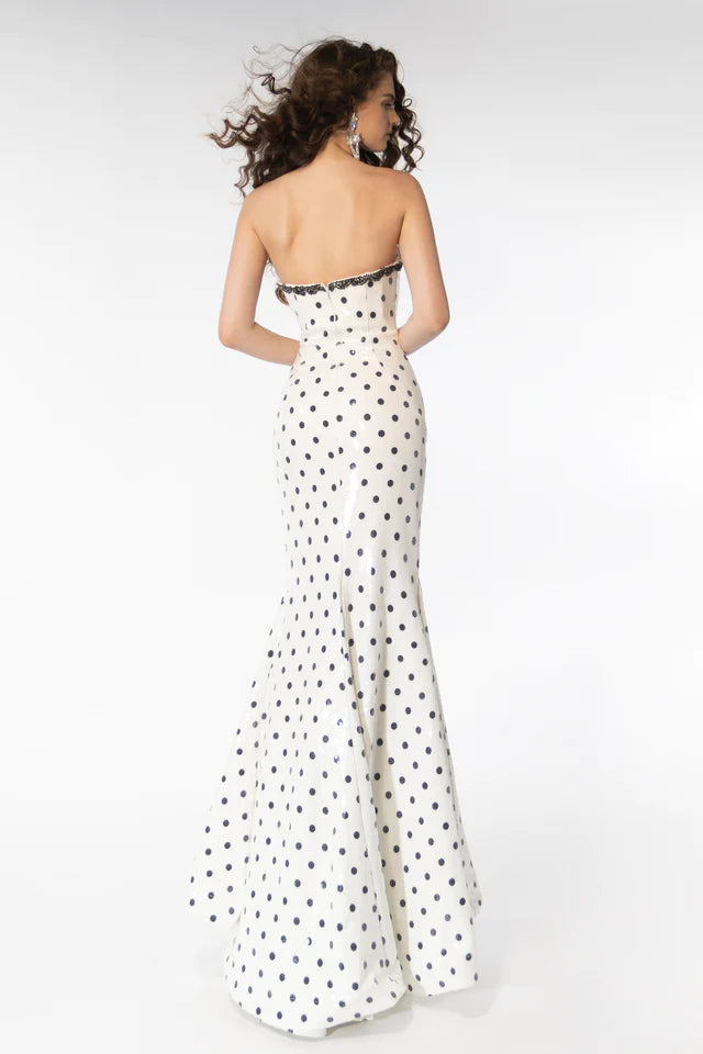 Dazzle the crowd in the stunning Ava Presley 39253 prom dress. Its strapless design and high slit add a touch of sophistication, while the sequin polka dot print and crystal detailing make it a showstopper. Be the belle of the ball in this formal gown.