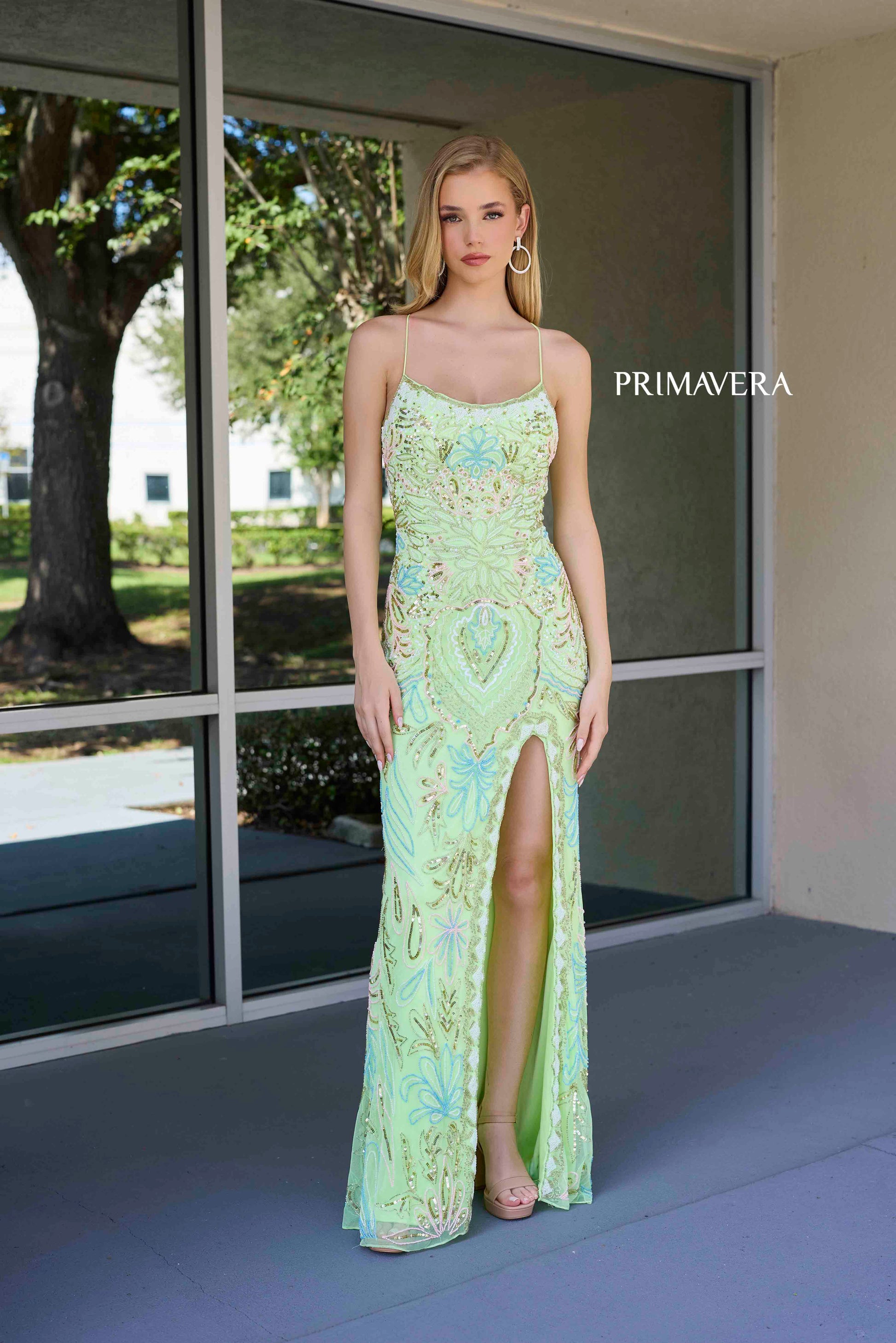 This Primavera Couture 4156 Long Prom Dress is the perfect choice for a sophisticated and glamorous look. With a fitted silhouette and scoop neck, this dress accentuates your curves while the sequin details add a touch of sparkle. The lace-up back and high slit provide a flattering and elegant touch, making it a must-have for formal occasions and pageant events.