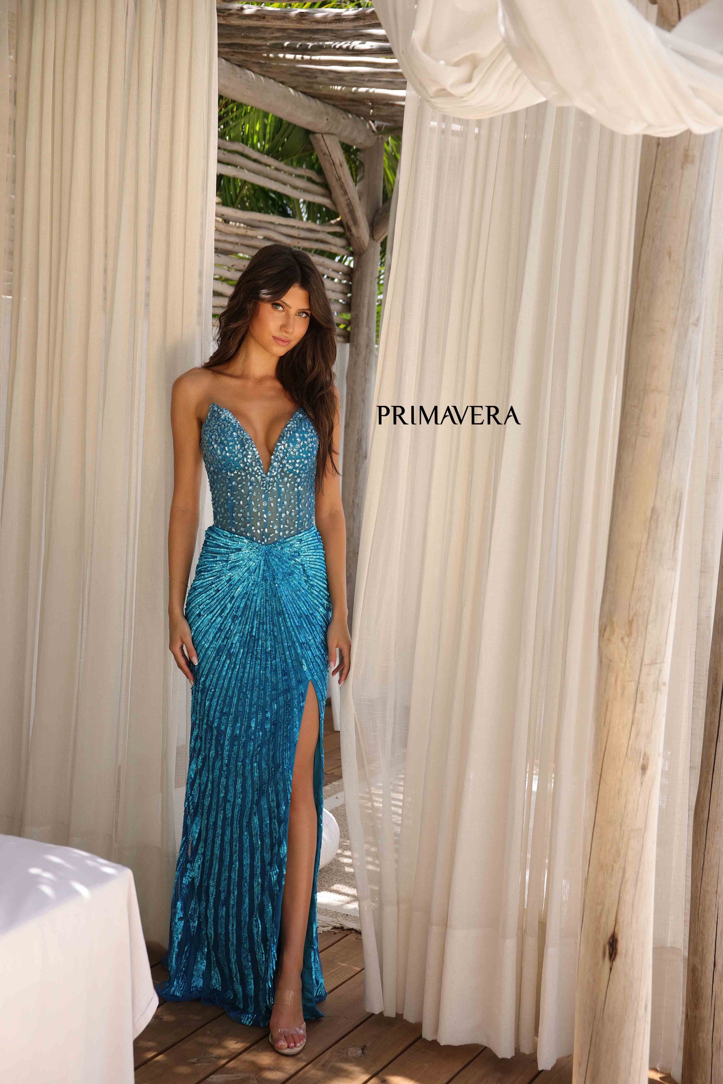 This elegant Primavera Couture 4304 Prom Dress features a sheer crystal corset, sequin detailing, and a dramatic slit in the skirt. The V-neckline adds a touch of sophistication, making it perfect for prom or pageants. Stand out from the crowd in this stunning gown.