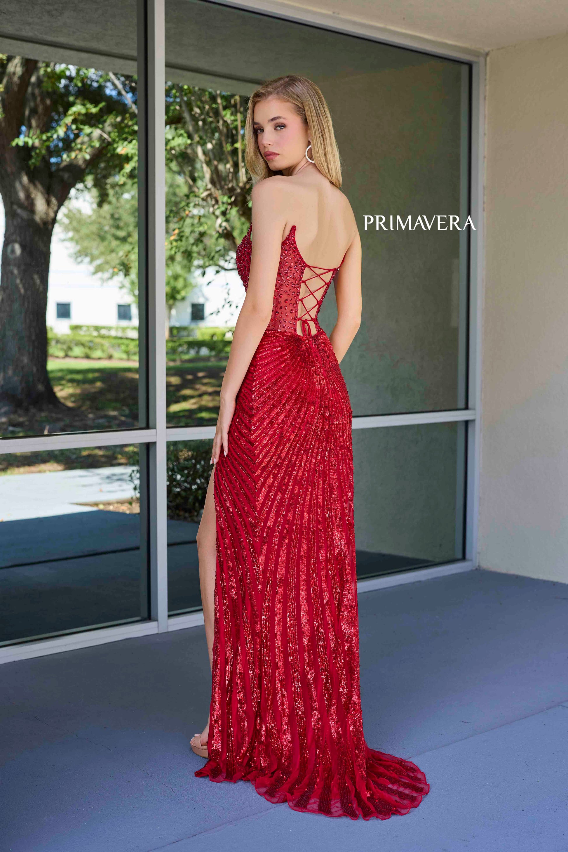 This elegant Primavera Couture 4304 Prom Dress features a sheer crystal corset, sequin detailing, and a dramatic slit in the skirt. The V-neckline adds a touch of sophistication, making it perfect for prom or pageants. Stand out from the crowd in this stunning gown.