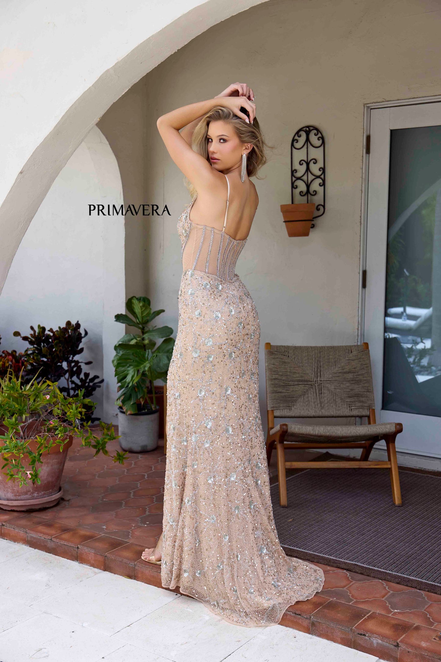 Elevate your prom or pageant look with the stunning Primavera Couture 4307 dress. The sheer paneling and crystal corset add a touch of elegance, while the sequin and bead detailing provide a subtle shimmer. With a flattering slit, this dress is both glamorous and effortlessly chic.