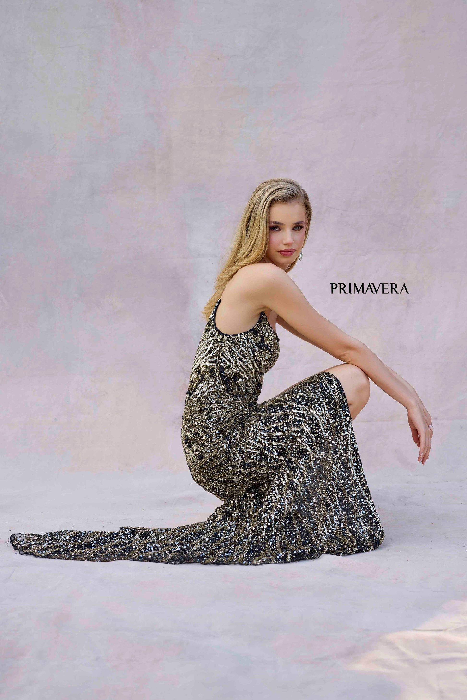 Elevate your prom or pageant look with the Primavera Couture 4343 dress. The long, beaded design features a v-neckline and corset bodice for a flattering, form-fitting silhouette. A high slit and sequin details add a touch of glamour to this elegant gown. Perfect for making a statement at your next event.