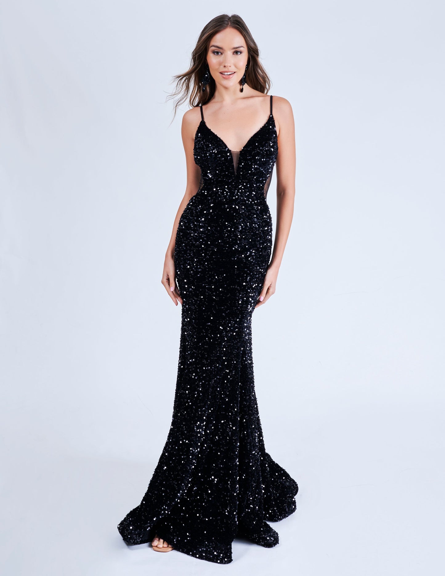 Elevate your style with the Nina Canacci 4420 Velvet Sequin Mermaid Prom Dress. Featuring a striking sheer v-neckline and stunning velvet sequin design, this formal evening gown is sure to make a statement. With its flattering mermaid silhouette, it's the perfect choice for a prom or special occasion.