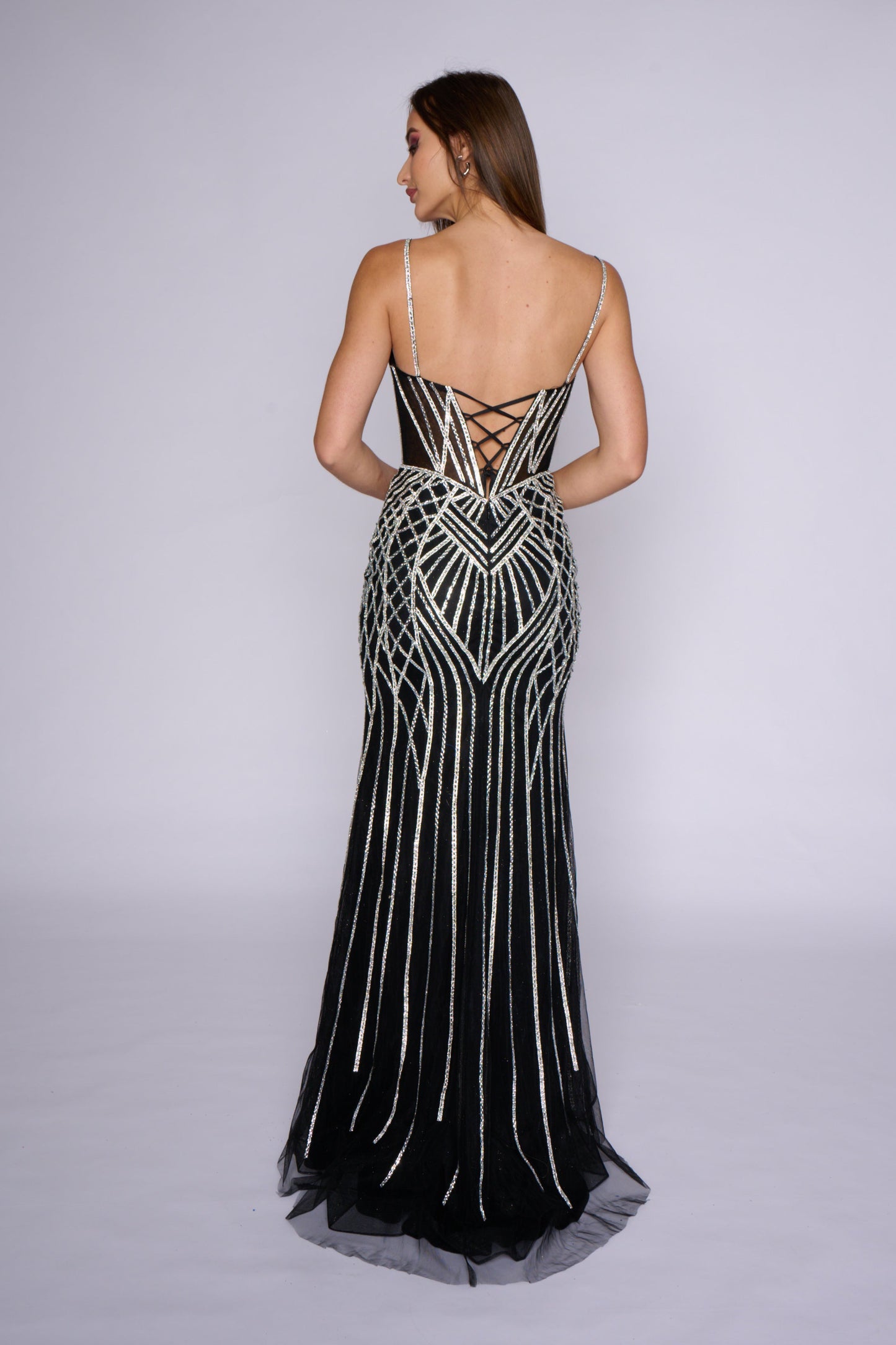 Experience elegance and sophistication in the Nina Canacci 4428 prom dress. This stunning evening gown features a sheer corset bodice with crystal detailing and a fitted silhouette for a flattering look. The V-neckline adds a touch of glamour to this formal dress. Elevate your wardrobe with this timeless piece.

Sizes: 0-14

Colors: Black, Gold/Silver, Blue/Silver