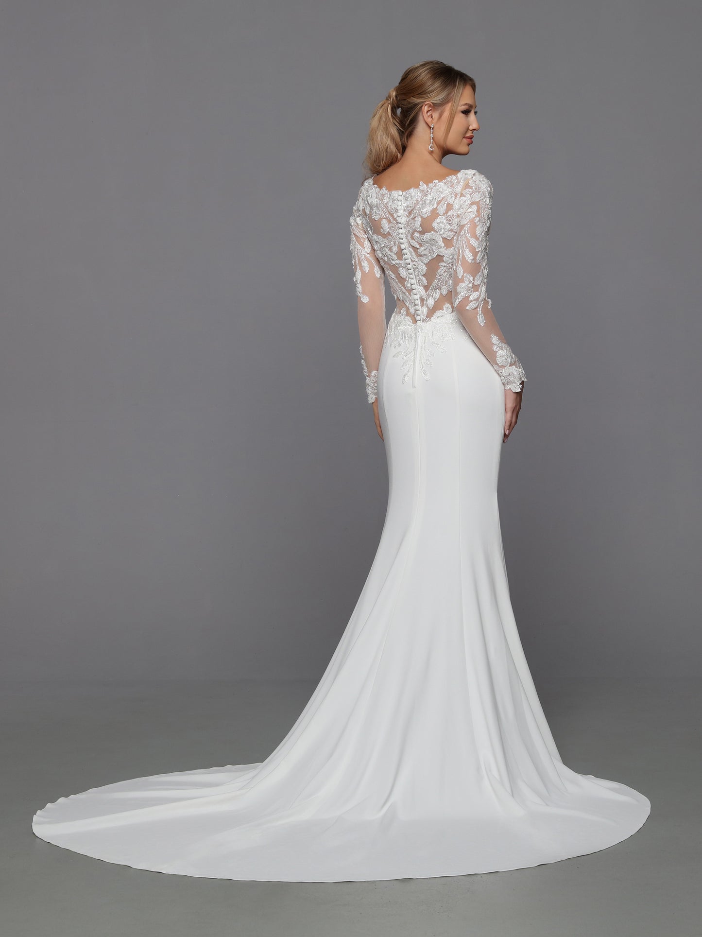 DaVinci Bridal 50776 Fit And Flare V-Neck Sheer Lace Applique Back Bodice Sleeves Train Wedding Gown. Sleek and sophisticated, this crepe fit and flare gown features removable full-length lace sleeves, a sheer lace applique back bodice, and a column of lustrous crepe finished with a chapel train.