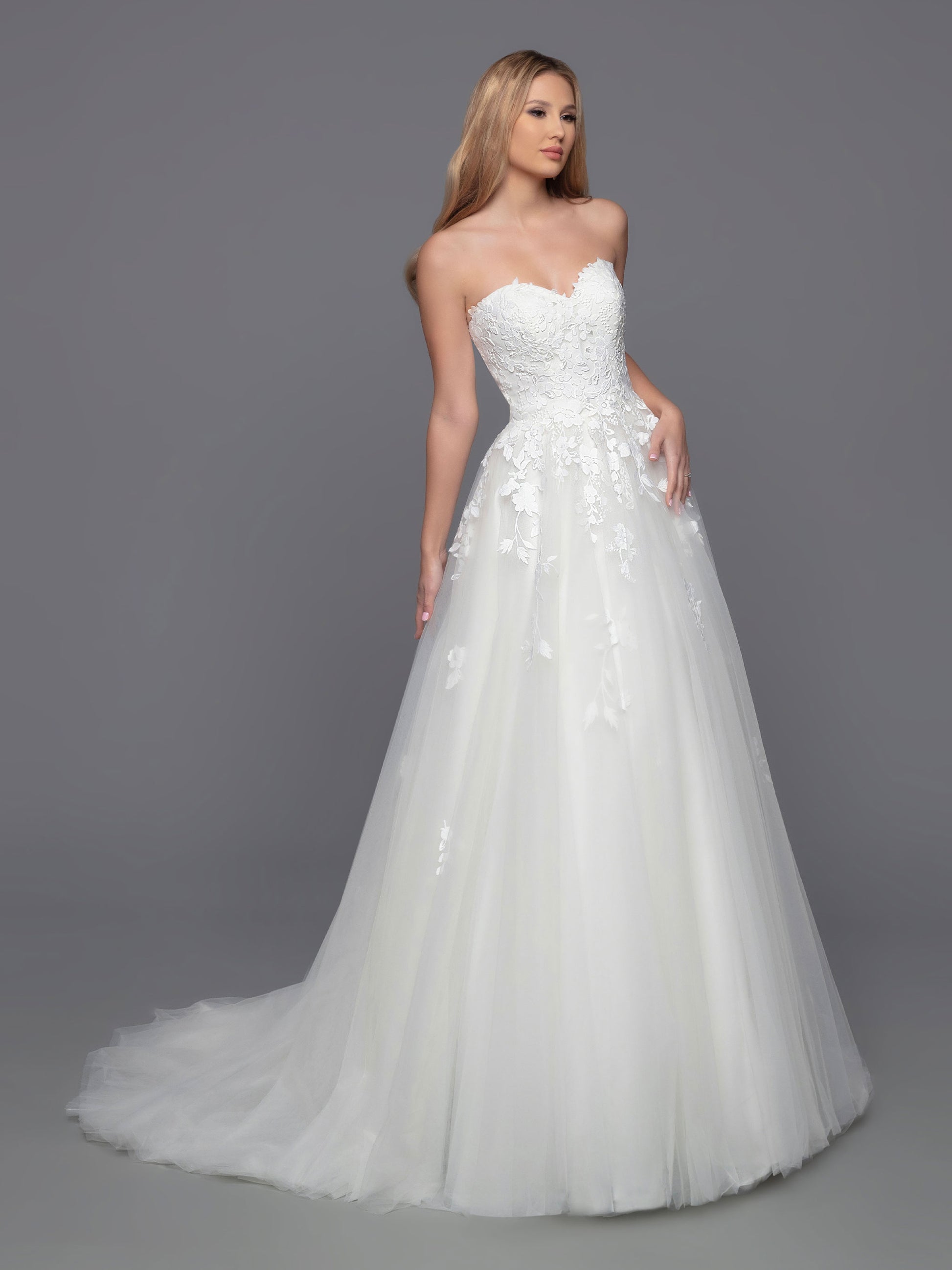 Look stunning on your big day with Davinci Bridal 50813. This beautiful tulle ballgown features a long a-line silhouette with a detachable lace long sleeve high neck jacket. Perfect for modest brides and cold weather weddings, the sheer lace bodice, back, and full-length sleeves create a breathtaking look. Lace accent at the waist of the layered skirt, and a chapel train, completes this stunning ensemble.  Sizes: 2-20  Colors: Ivory