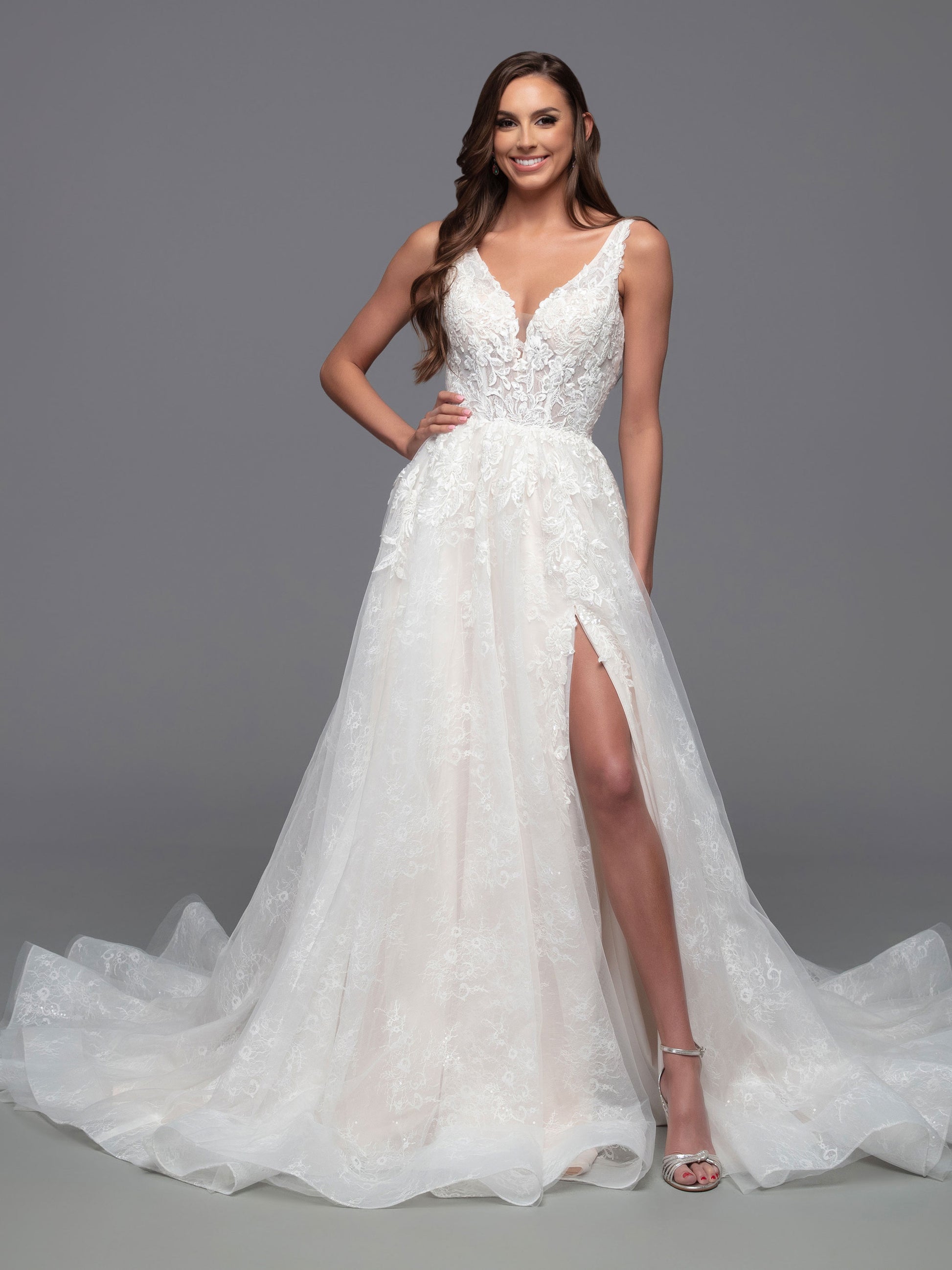 The Davinci Bridal 50821 is a stunning choice for a wedding dress, featuring a fitted V-neckline, sheer bodice, and a gorgeous a-line maxi skirt with a chapel length train and delicate sequin detailing. The daring slit skirt adds a daring touch for a timeless yet modern look.  Sizes: 2-20  Colors: Ivory/Ivory, Ivory/Light Blush