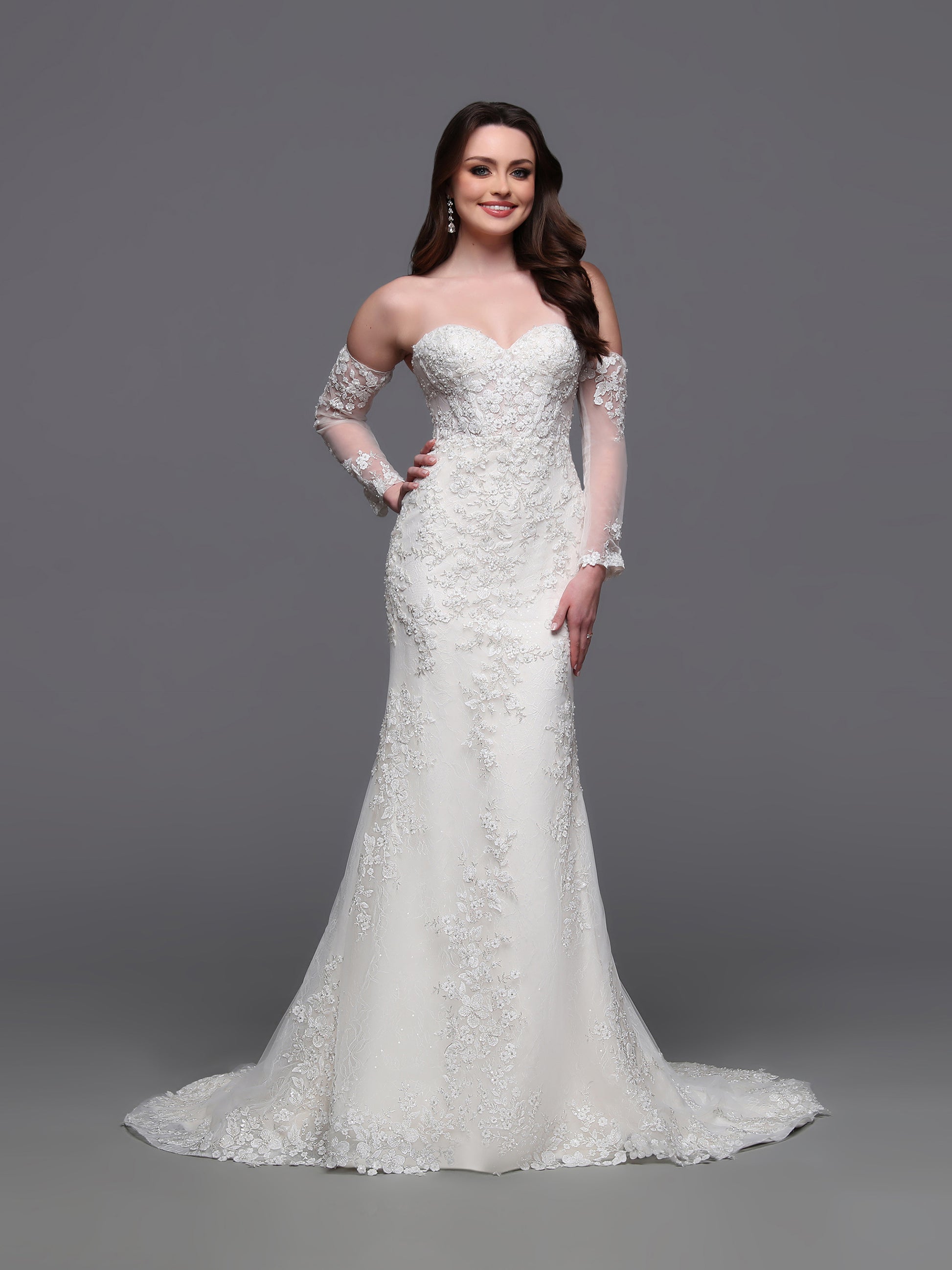 Indulge in elegance on your special day with the Davinci Bridal 50881 wedding dress. Flowing lace and intricate beading adorn the off the shoulder long-sleeves and corset back&nbsp; gown, leading into a stunning train. This mermaid-style dress is perfect for the modern bride who wants to make a statement. sequin shimmer