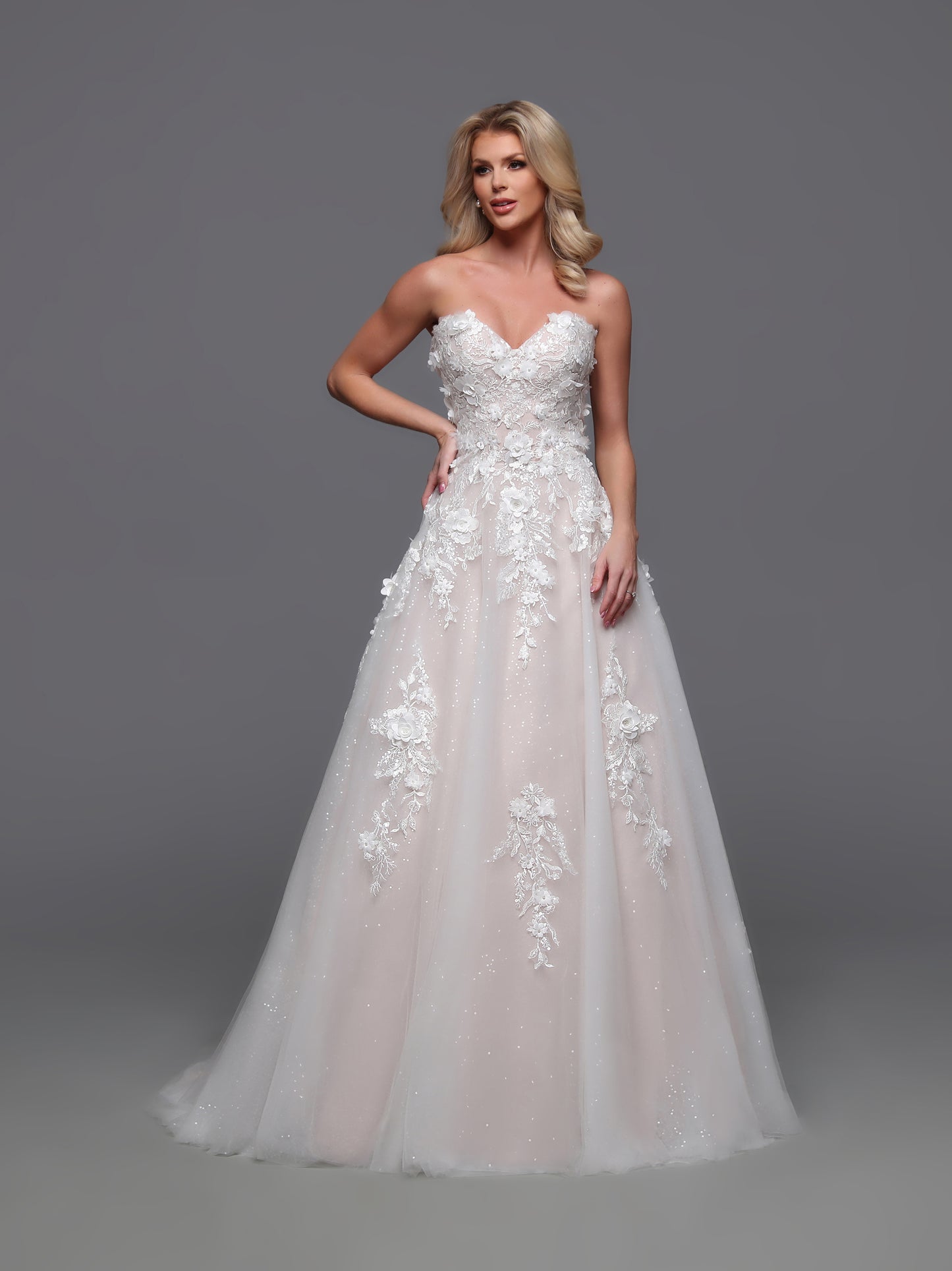 Elevate your elegance with the Davinci 50883 wedding dress. Beautifully designed with a detachable off shoulder sleeve and corset bodice, this A line lace gown exudes luxury. The sequin shimmer ballgown adds a touch of glamour, creating a one-of-a-kind bridal look that will leave a lasting impression.