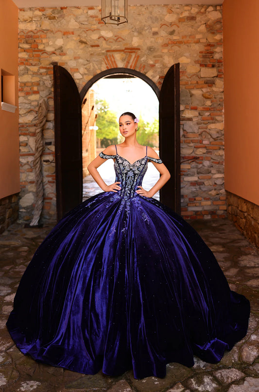 This elegant Amarra 54316 Velvet quinceanera dress is designed with a crystal corset, off-the-shoulder neckline, and princess ball gown silhouette. Made with soft velvet fabric, this dress will make any quinceanera celebration unforgettable. Perfect for a formal party or special occasion, this dress exudes sophistication and grace.