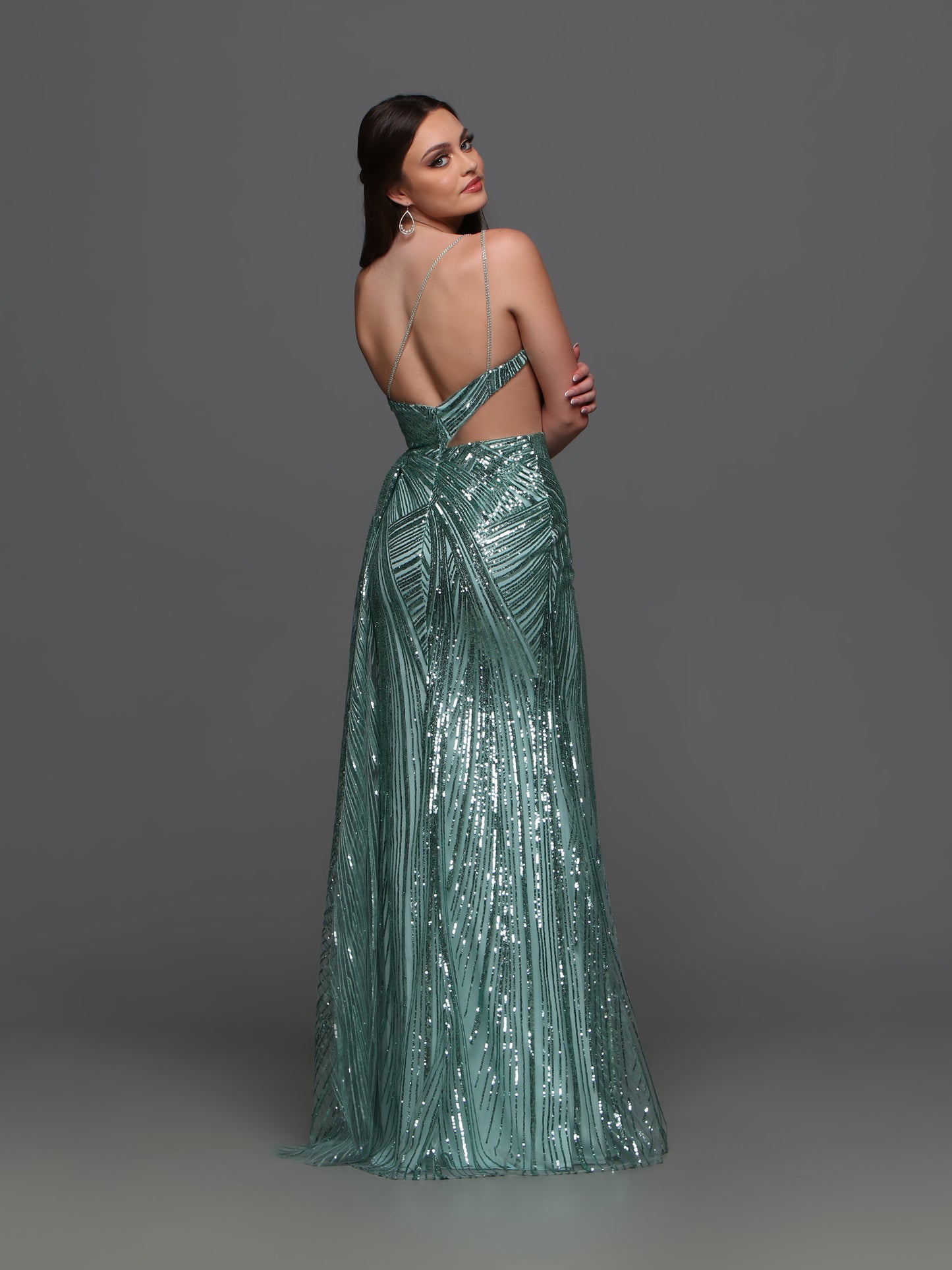 Elevate your formal look with the Candice Wang 72323 Sequin One Shoulder Cutout Dress. The sequin detailing adds a touch of glamour while the one shoulder and cutout design creates a sophisticated silhouette. The overskirt and maxi slit add a modern twist to this classic gown.  Sizes: 0-16  Colors: Sage