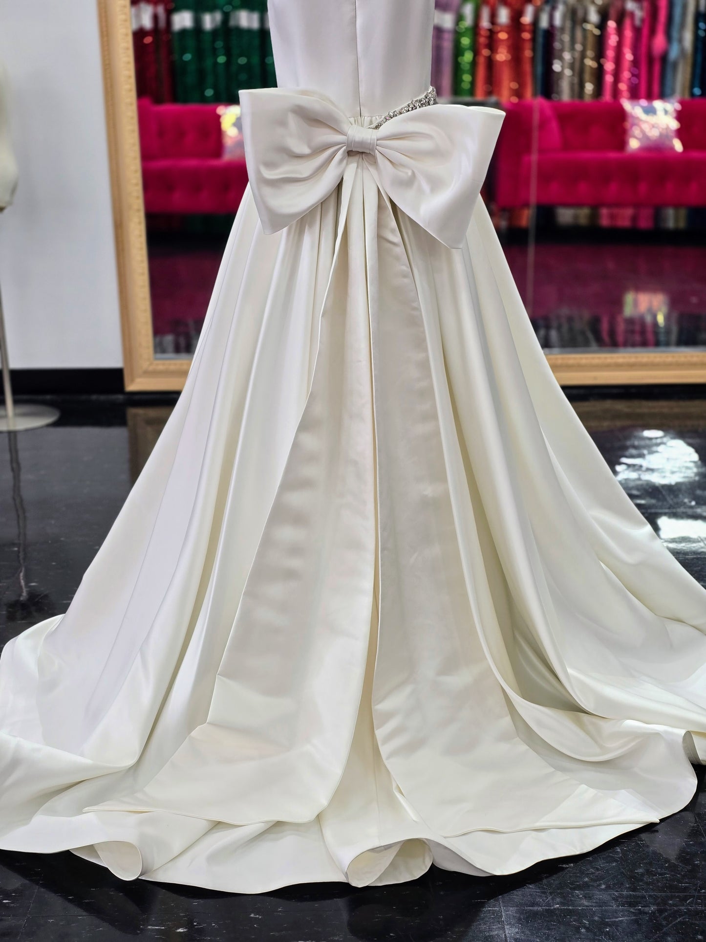 This Ashley Lauren 8079 Size 12 Ivory Long satin A Line girls Pageant Dress features an elegant crew neckline, a crystal encrusted waistline, and an A-line skirt that is complemented by a detachable bow at the back. Perfect for formal occasions, this high-quality gown will make your little girl look beautiful.