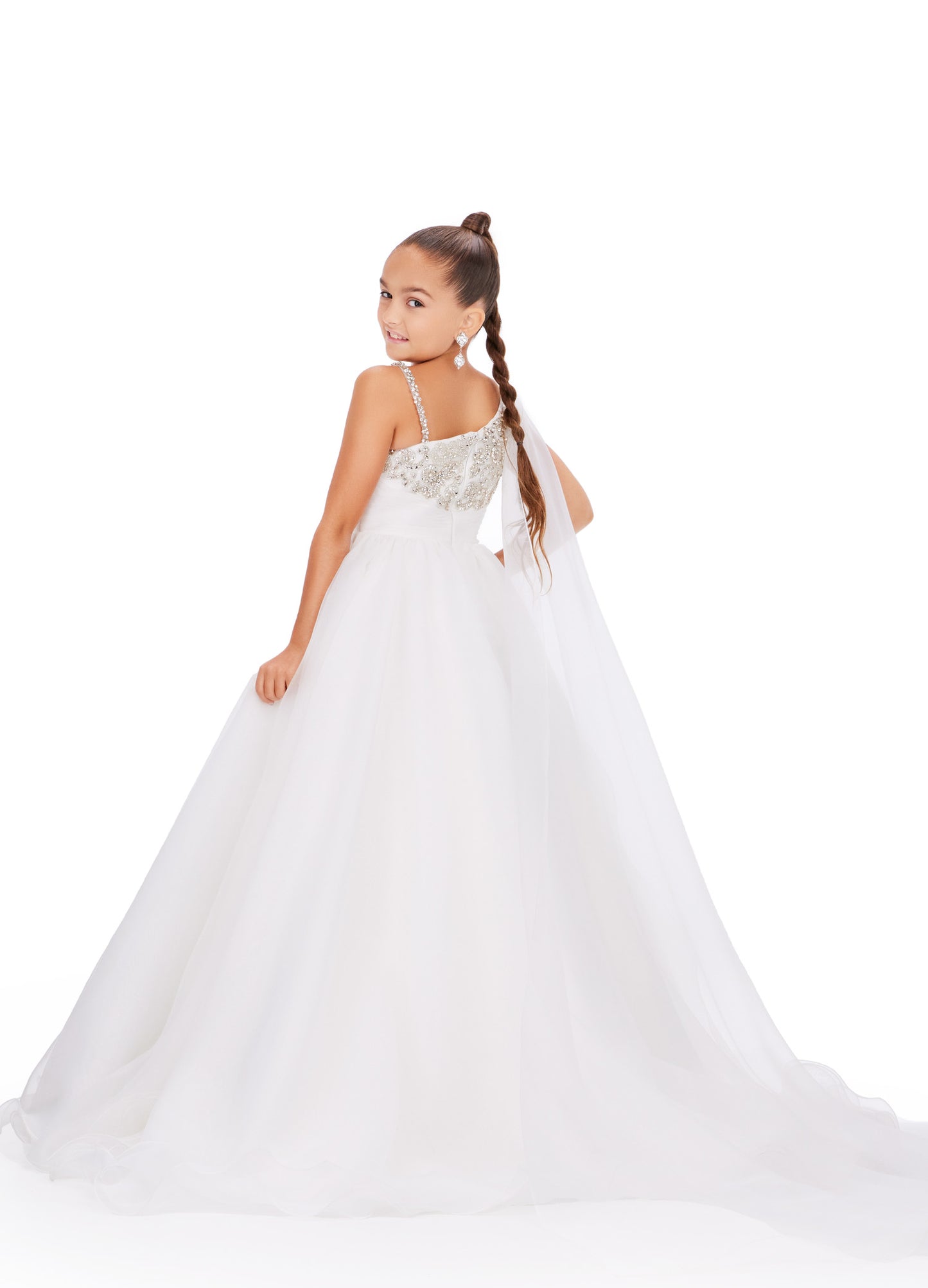 This Ashley Lauren Kids 8212 one-shoulder girls' pageant dress is both elegant and fun. With a cape design and crystal embellishments, this A-line ball gown is perfect for any pageant or special occasion. Look and feel like a princess in this stunning dress. This gorgeous organza ball gown is meant for a future queen! Featuring a stunning beaded bustier and one shoulder cape, this gown is sure to stun!