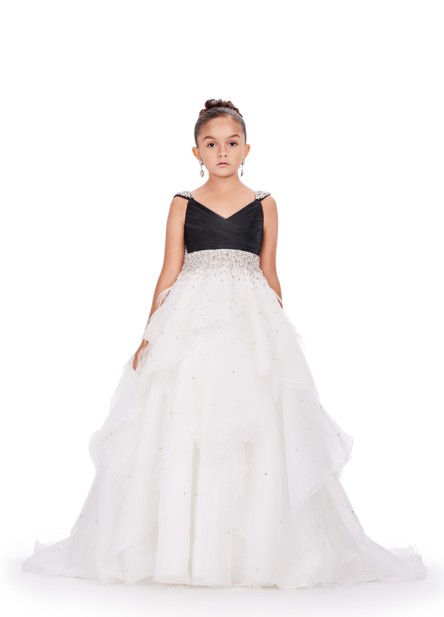 Elevate your little one's pageant look with the Ashley Lauren Kids 8219 Girls Layered Feather Pageant Dress. This stunning ballgown features a V-neck embellished with feathers, adding a touch of glamour to the overall design. With its layered skirt, this dress will make your child feel like a princess on stage. Be the star of the show in this fabulous organza ball gown