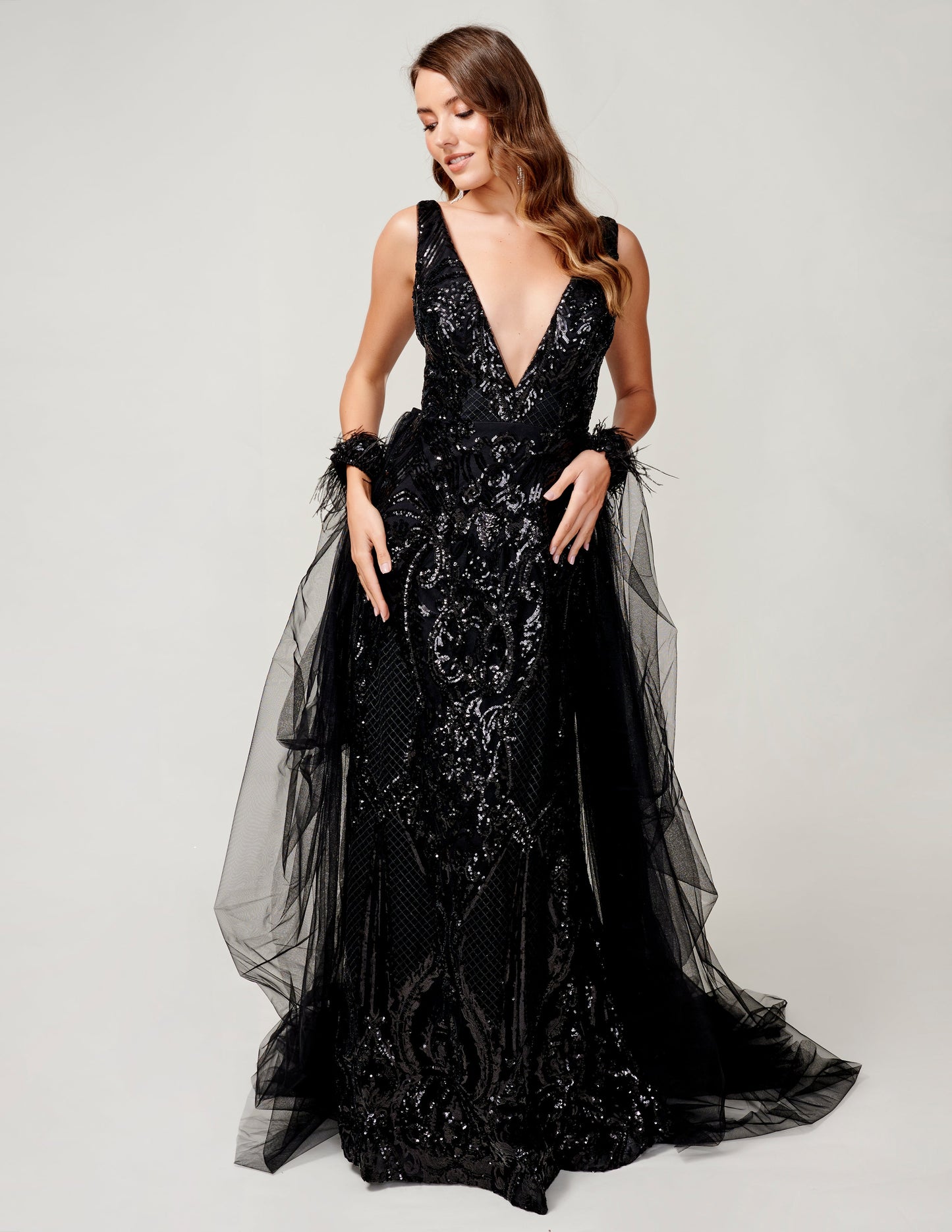 <p data-mce-fragment="1">This stunning Nina Canacci 8224 long, fitted pageant dress features a dazzling sequin design and a detachable tulle overskirt with a feather cuff. The elegant V-neckline adds a touch of sophistication to this show-stopping gown. Perfect for any formal event or pageant, this dress is sure to make a statement.</p> <p data-mce-fragment="1">&nbsp;</p>